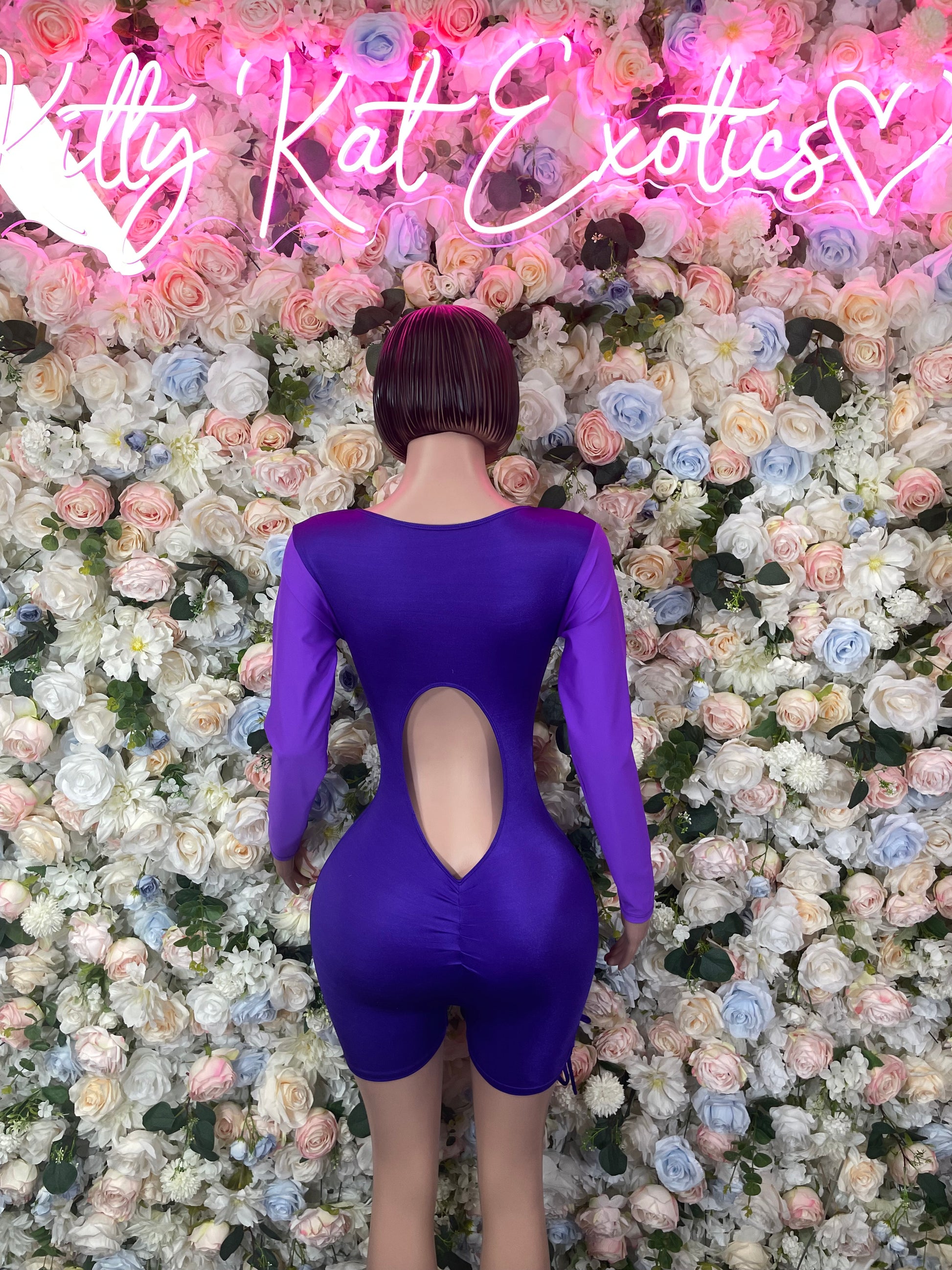 Purple long-sleeve one-piece bodysuit with open back cutout