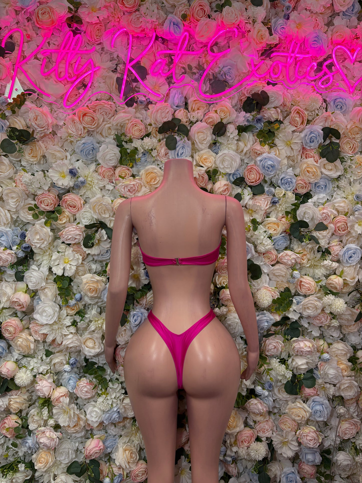 Pink two-piece bikini set with strappy back and high-cut thong bottoms, back view