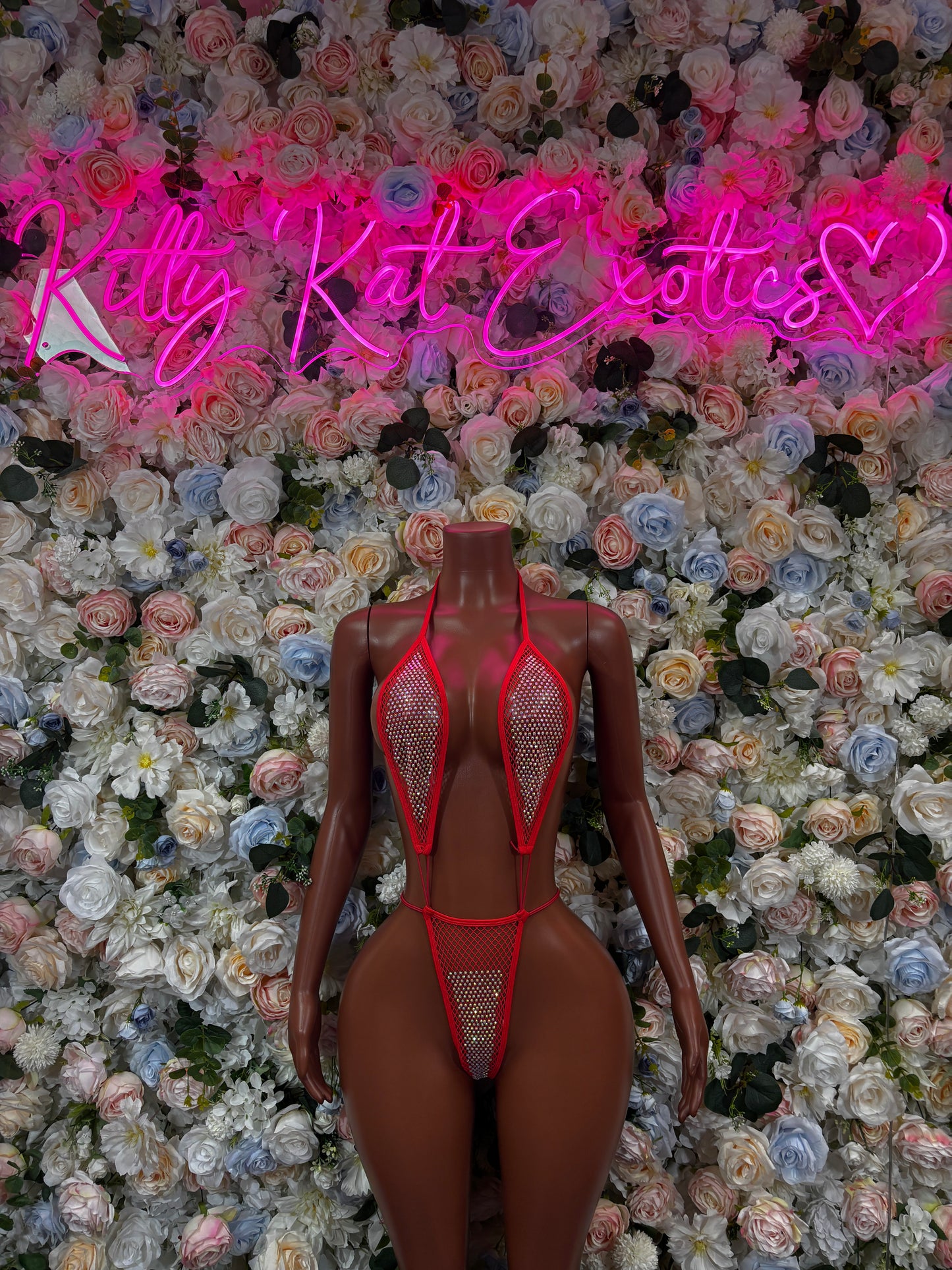 Red fishnet slingshot bodysuit with halter straps and thong back