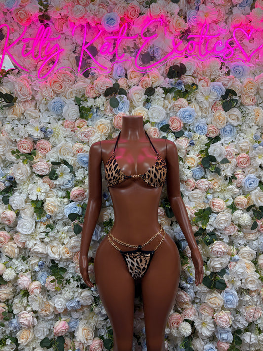 Leopard print pink two-piece bodysuit set with bra top and thong bottoms, chain accents