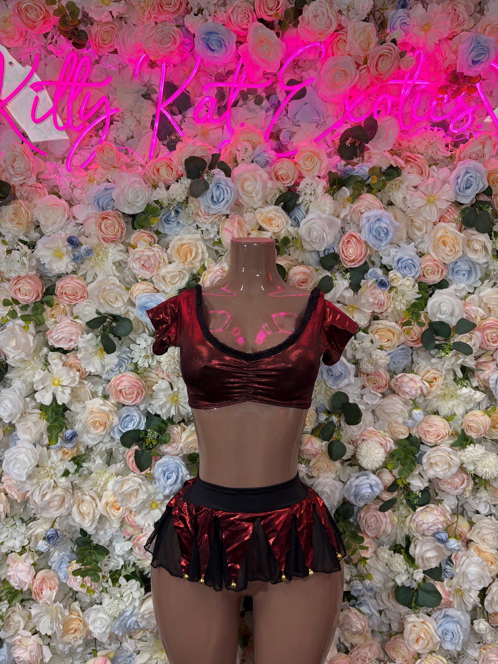 Burgundy metallic crop top and ruffled mini skirt set on mannequin