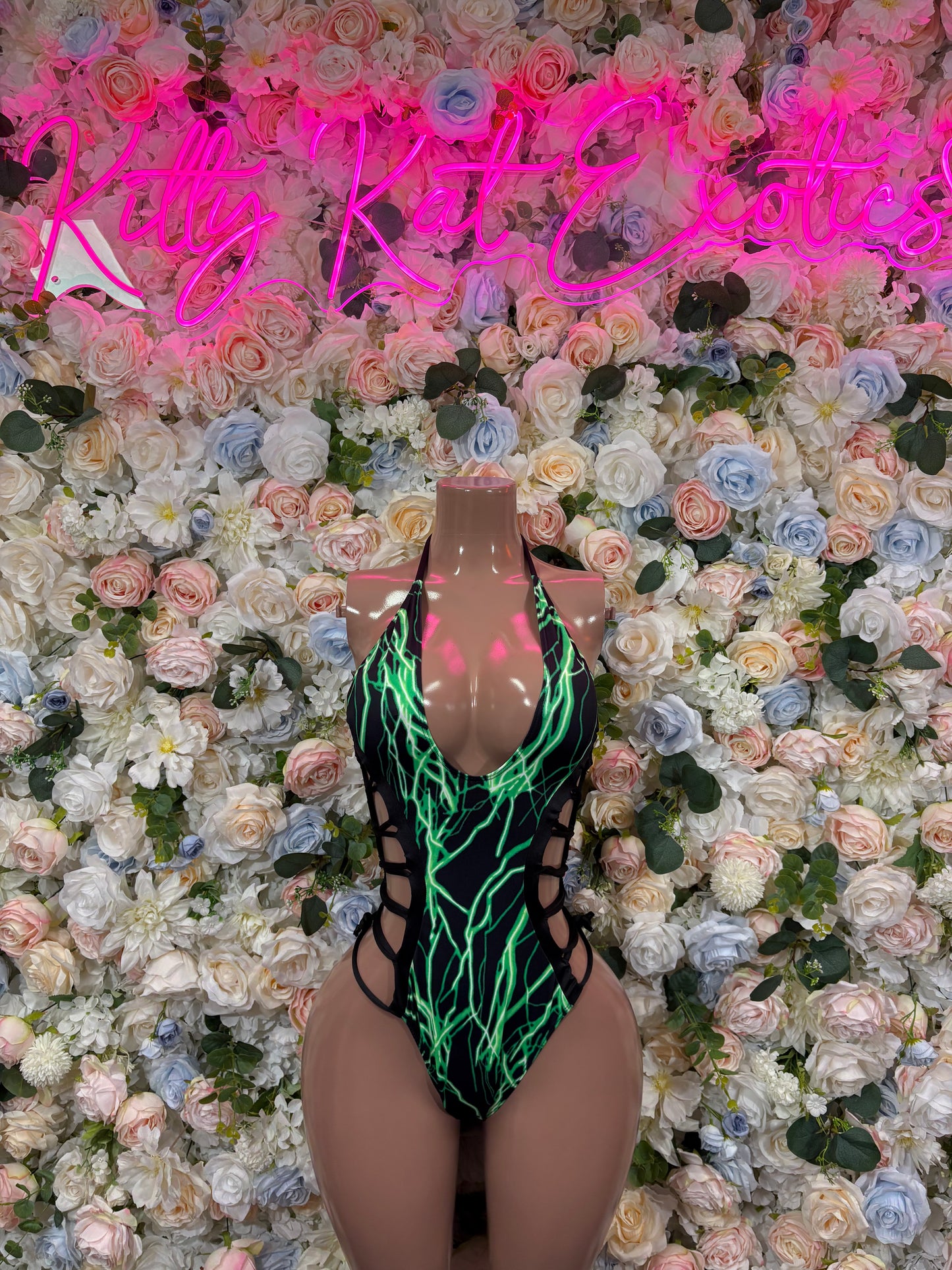 Green and black one-piece bodysuit with halter neck and crisscross trim