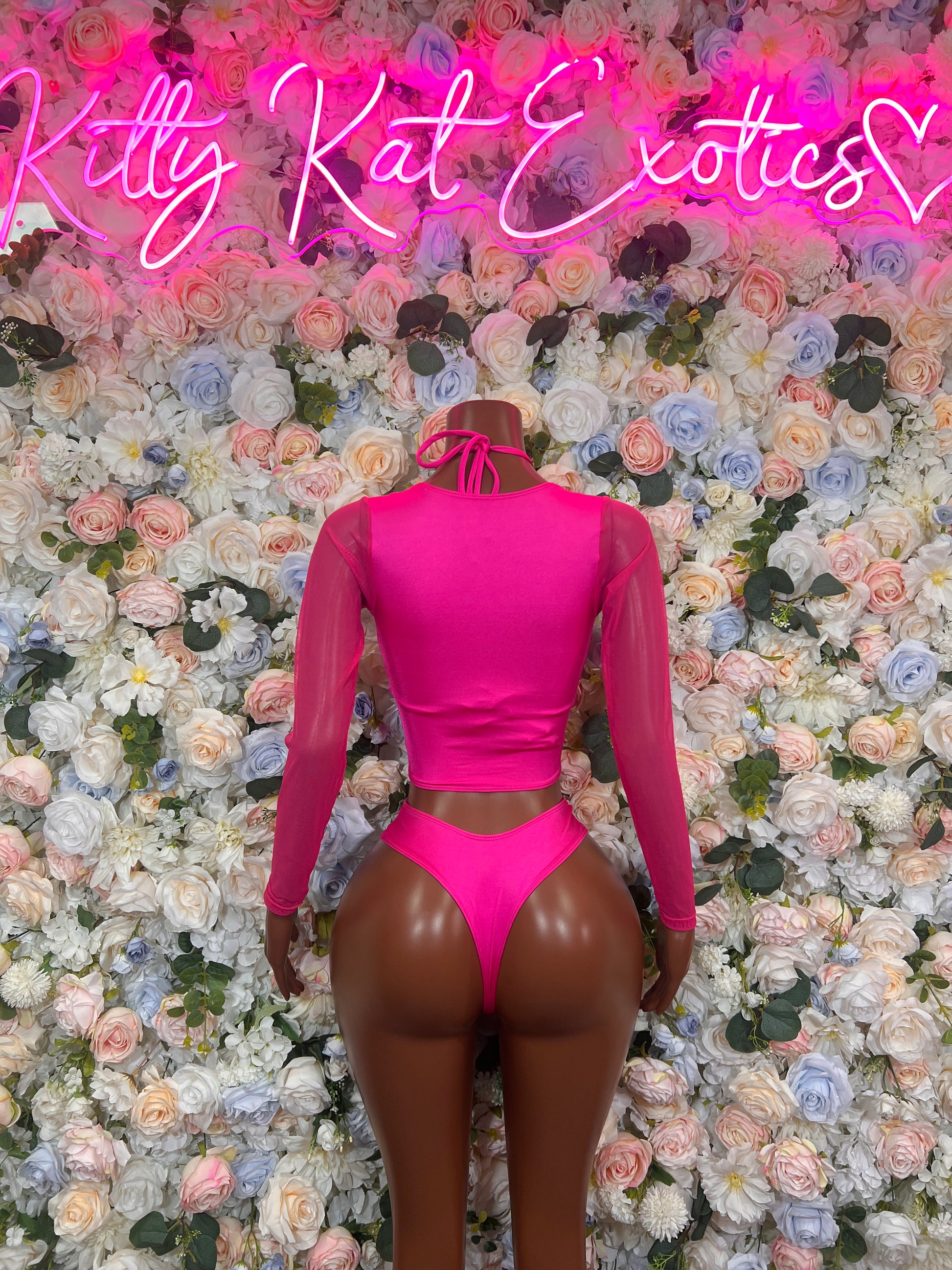 Back view of a model wearing a stylish pink bodysuit club wear, perfect for bartending and exotic dance performances.