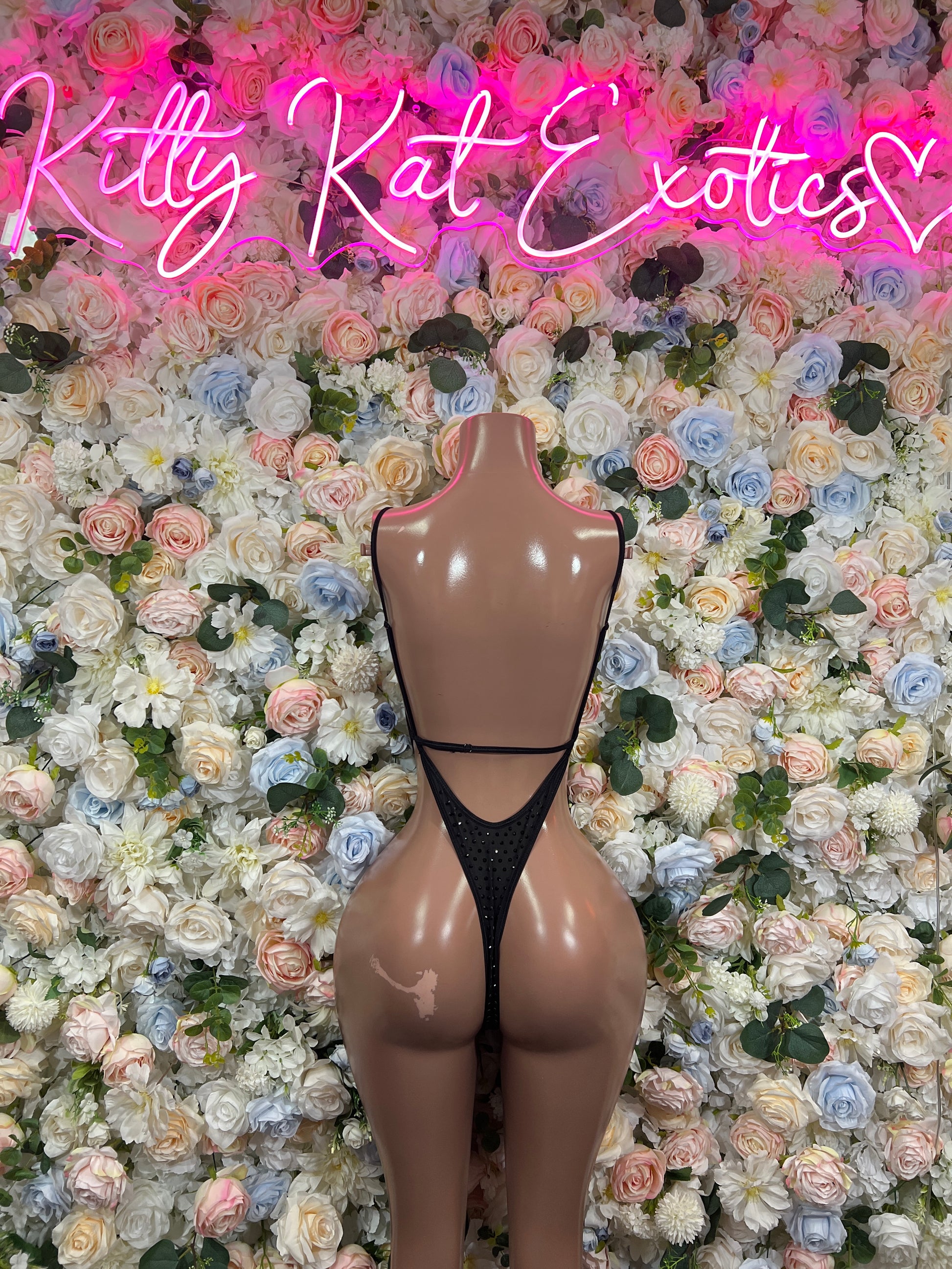 Dark rhinestone one-piece bodysuit on mannequin, V-neck, open back and thin straps