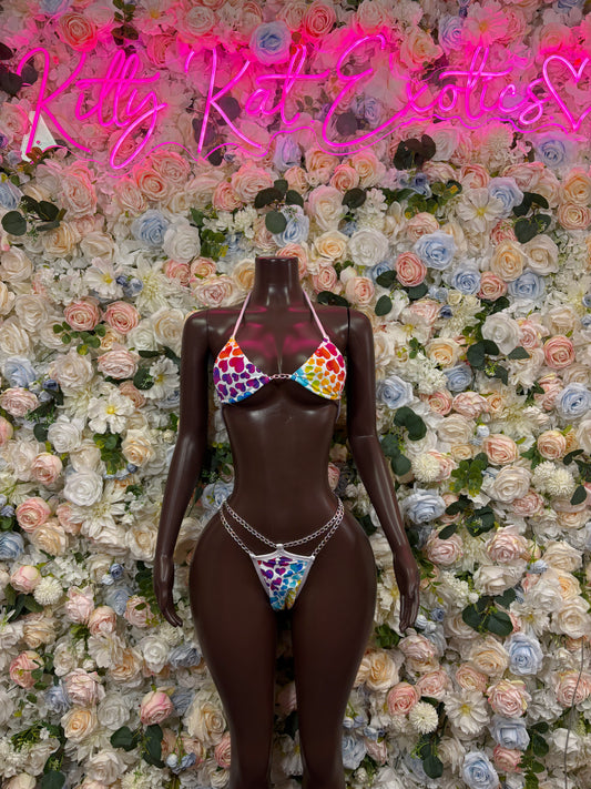 Two-piece heart print bodysuit set on mannequin, rainbow trim and multicolor hearts