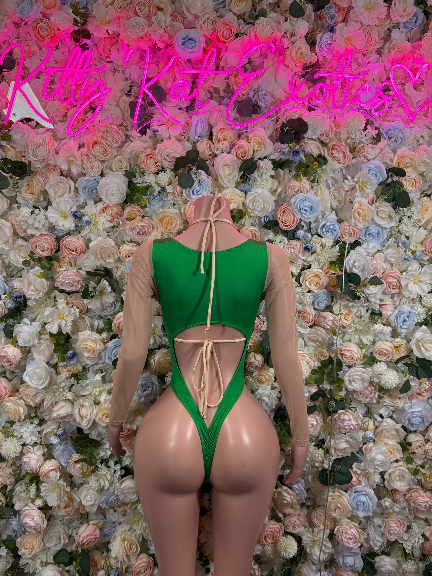 Green backless bodysuit with center cutout and lace-up tie detail