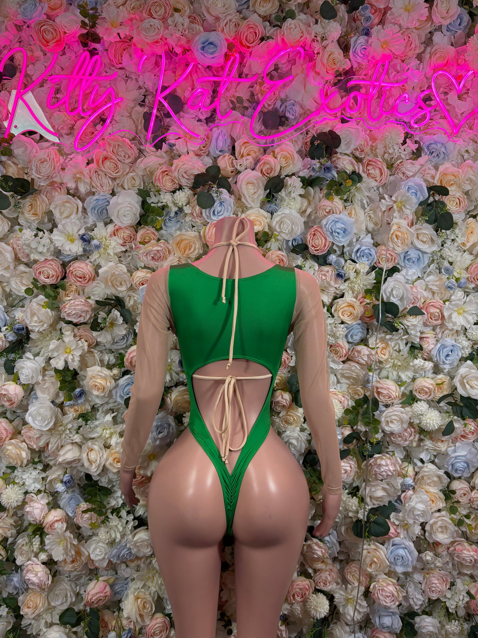 Green backless bodysuit with center cutout and lace-up tie detail