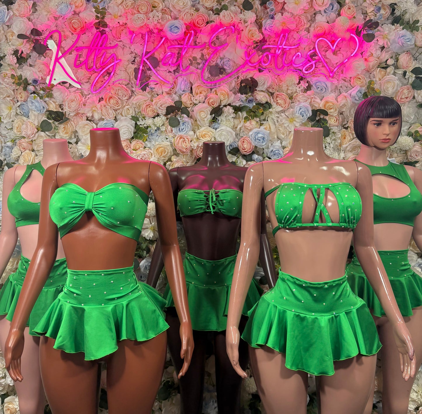 Green skirt set trio on mannequins: bow bandeau and ruffled mini skirt