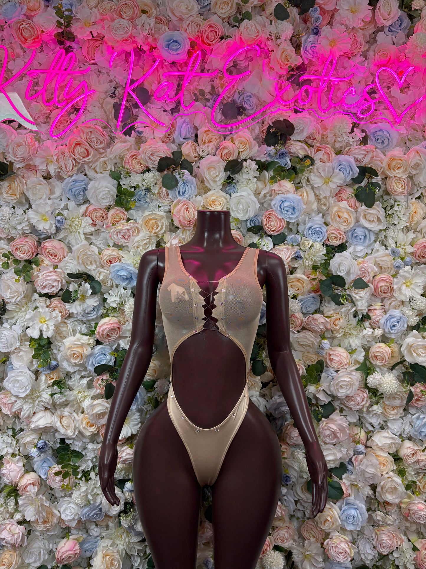 Nude one-piece bodysuit with scoop neckline and high-cut leg openings