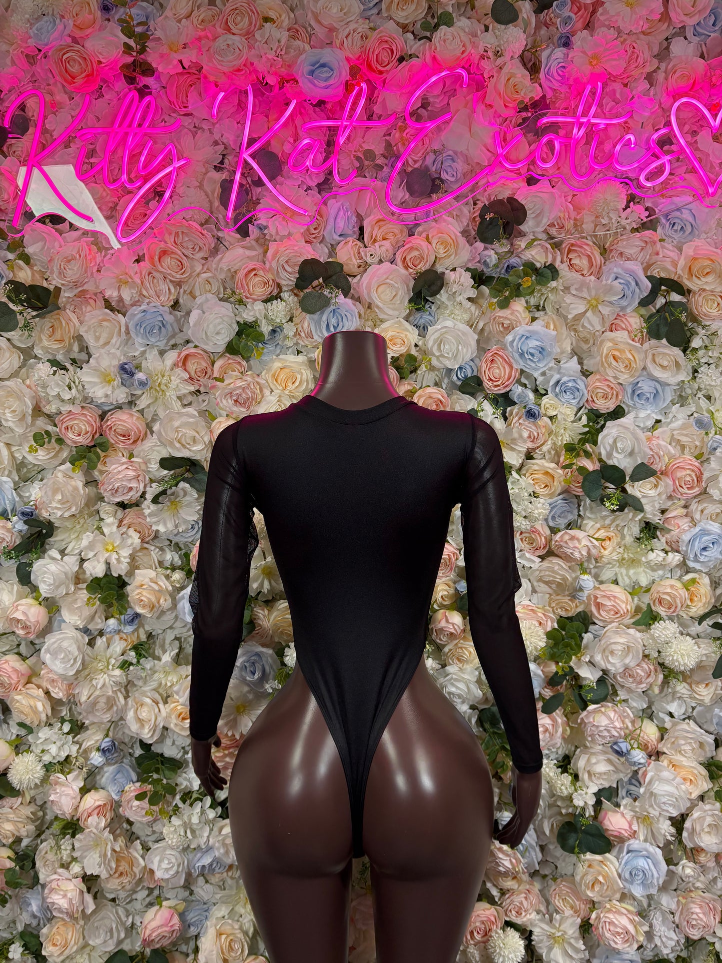 Black one-piece bodysuit with sheer long sleeves and neon green/yellow lightning back