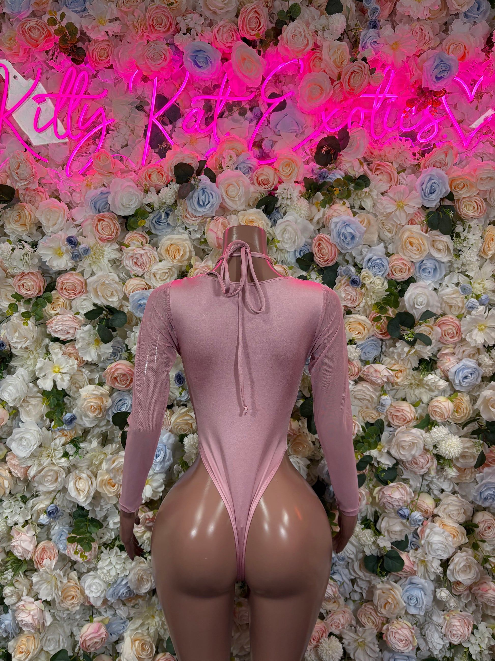 Rose pink velvet bodysuit with long sleeves, lace-up open back and high-cut thong