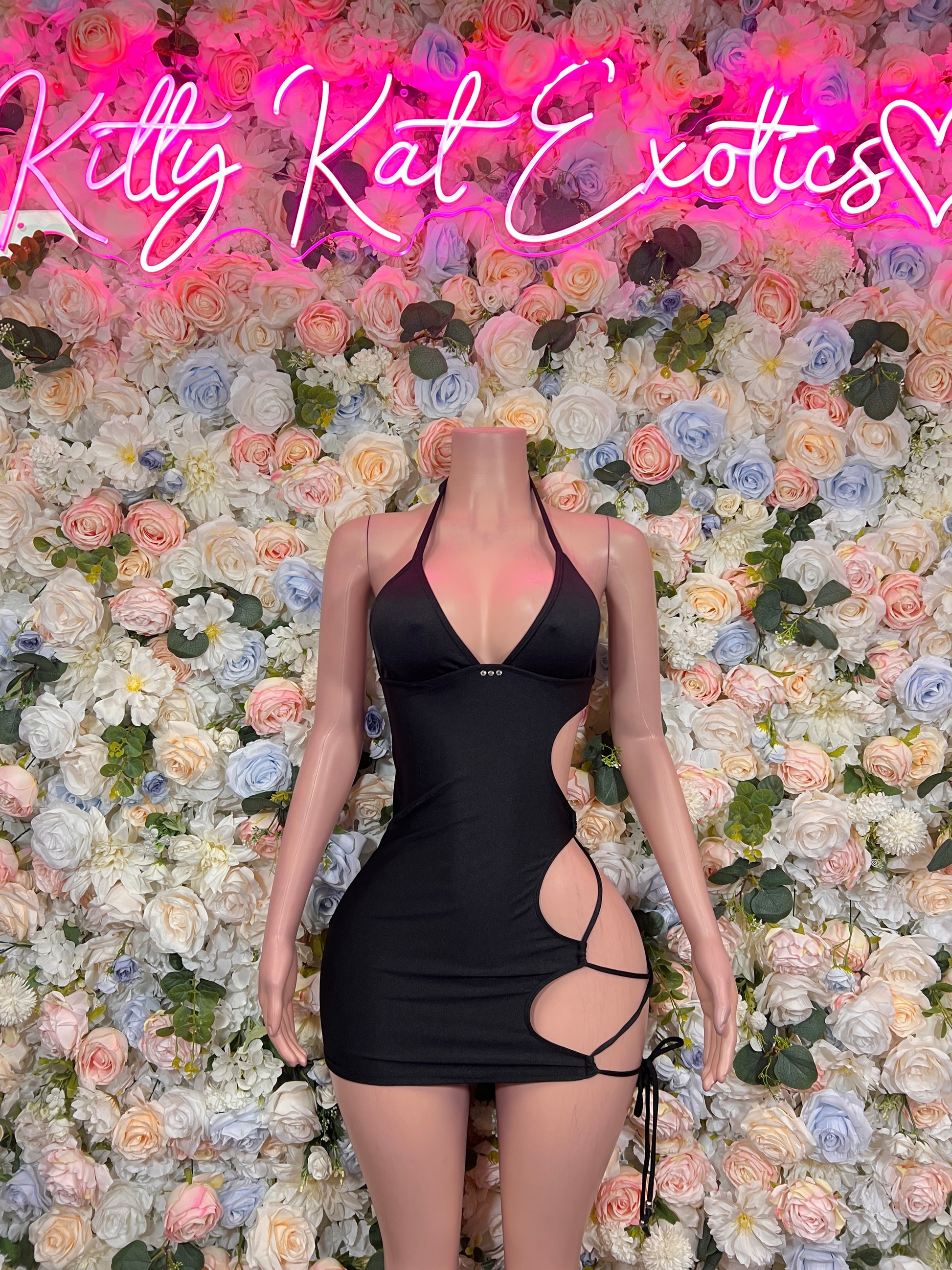 Black halter mini bodycon dress with side cutouts and strappy back tie