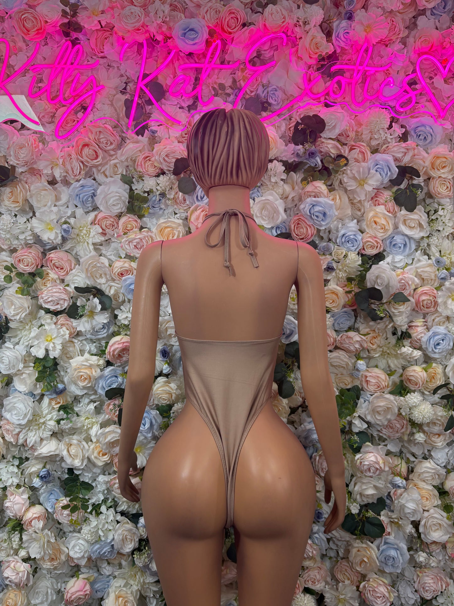 Tan dance bodysuit one-piece back view with tie strap and high-cut leg openings
