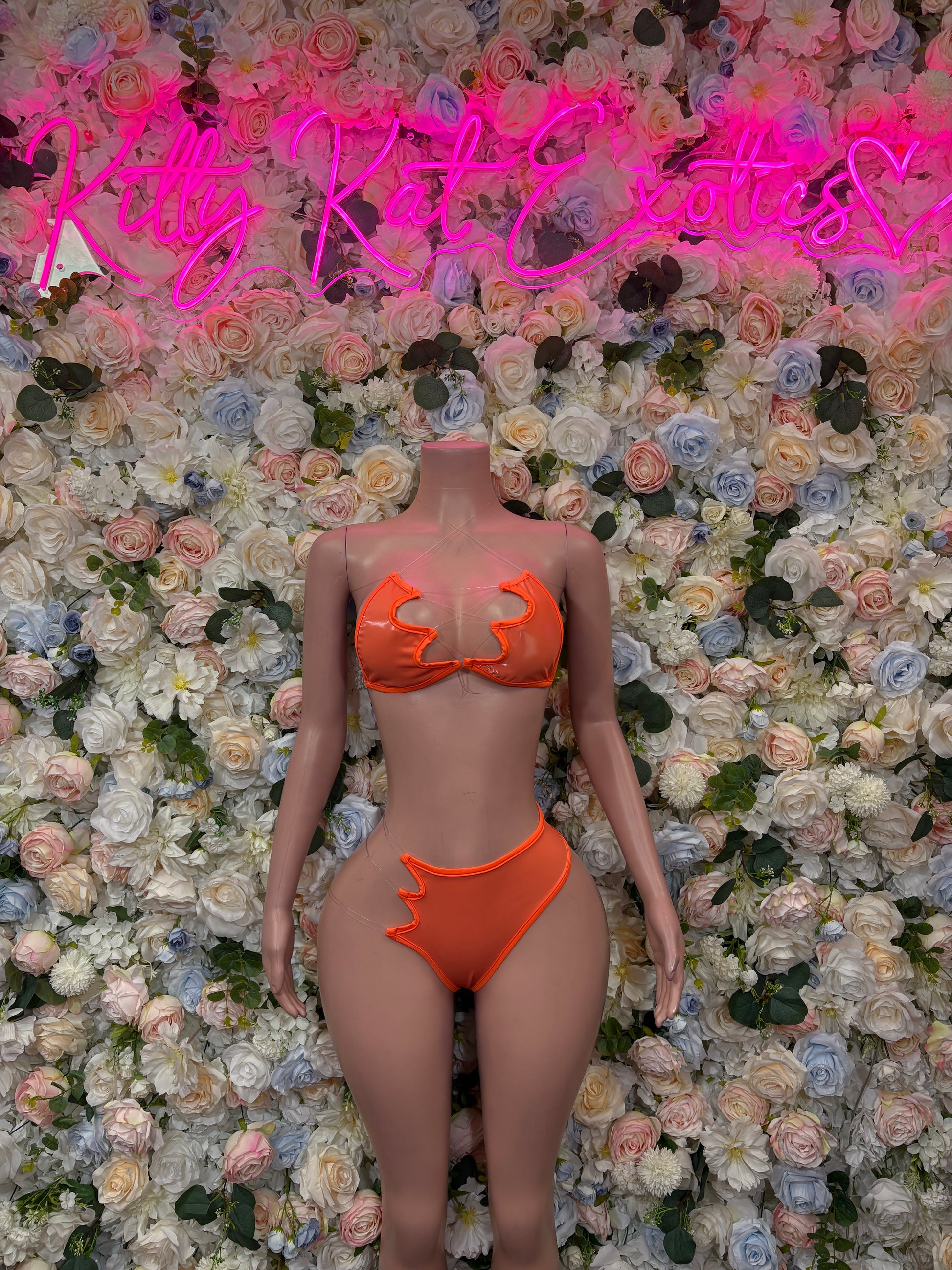 Orange two-piece bikini set with scalloped trim, triangle top and high-waist bottoms