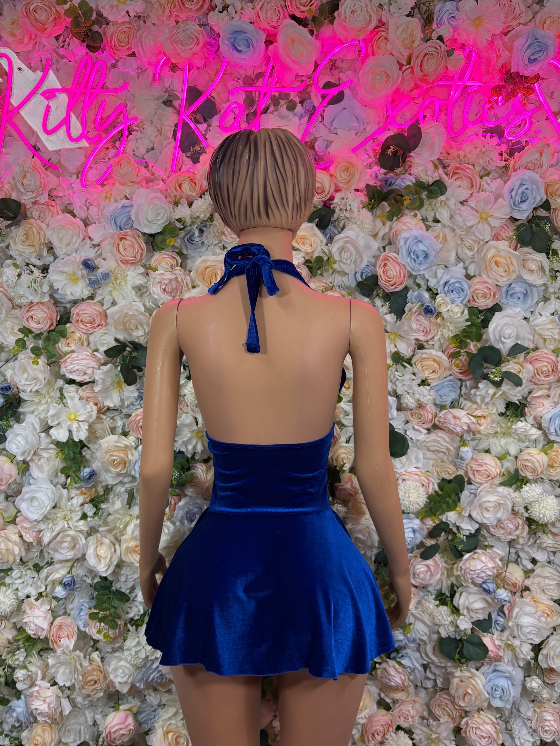 Blue velvet halter mini dress with open back and tie strap, flared skater hem.