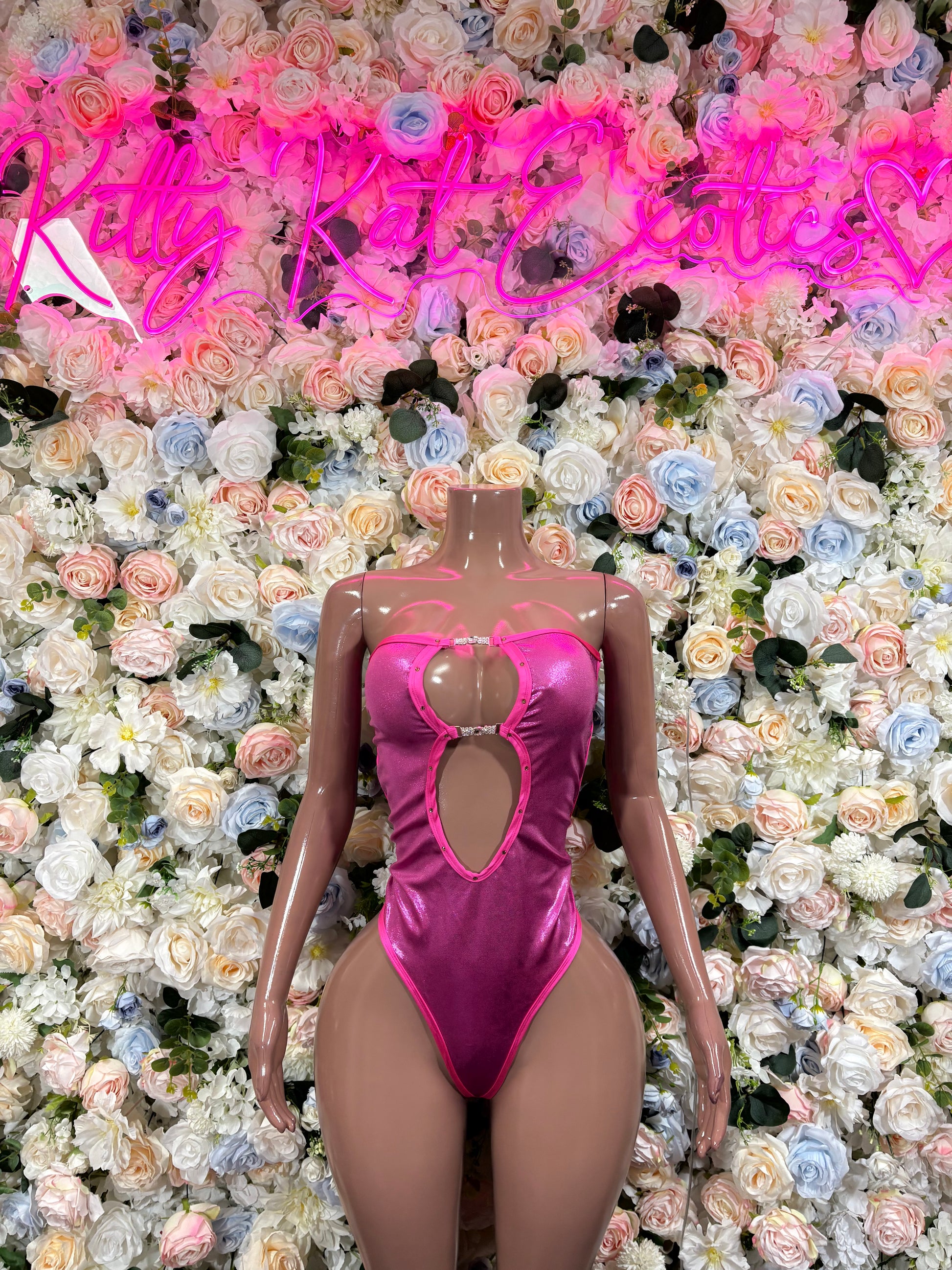 Metallic pink one-piece rave bodysuit with front heart cutout and keyhole