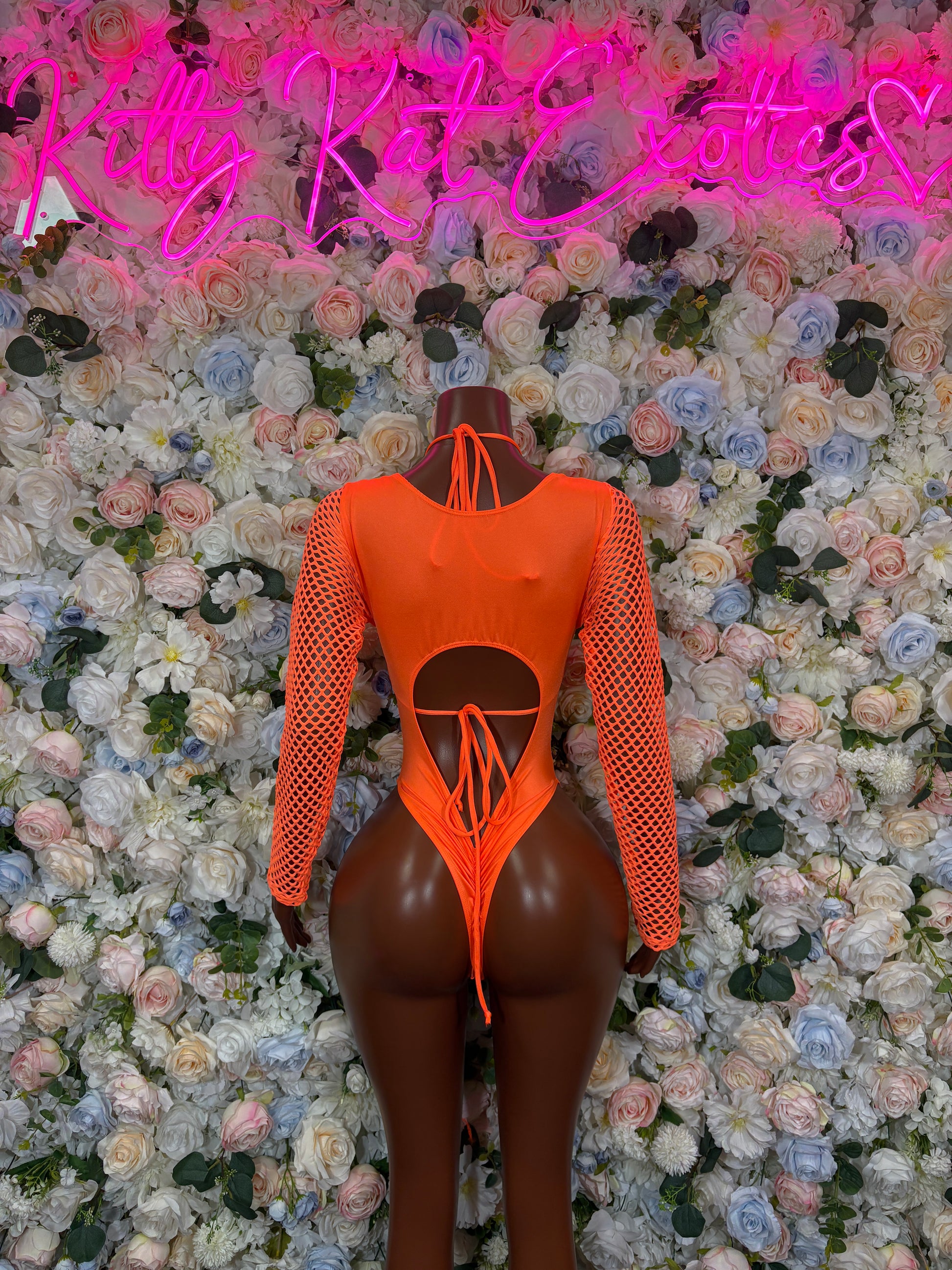 Orange one-piece bodysuit with fishnet long sleeves and central bow