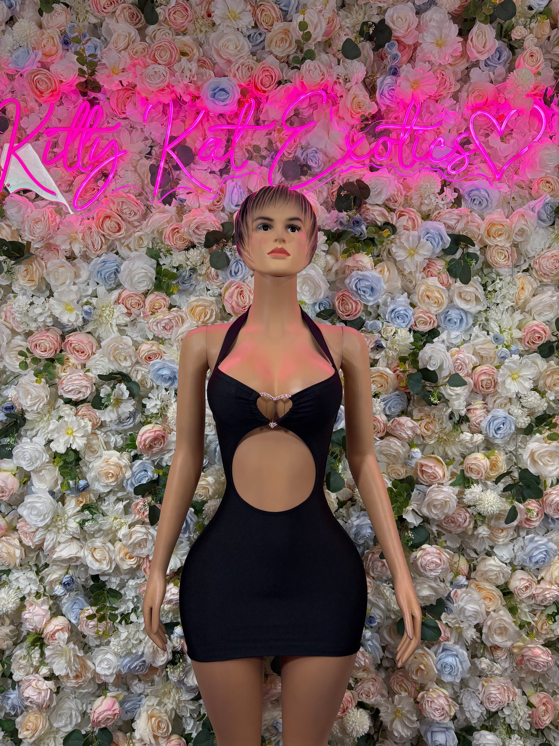 Black dance dress with halter straps, oval cutout front, and gold heart detail