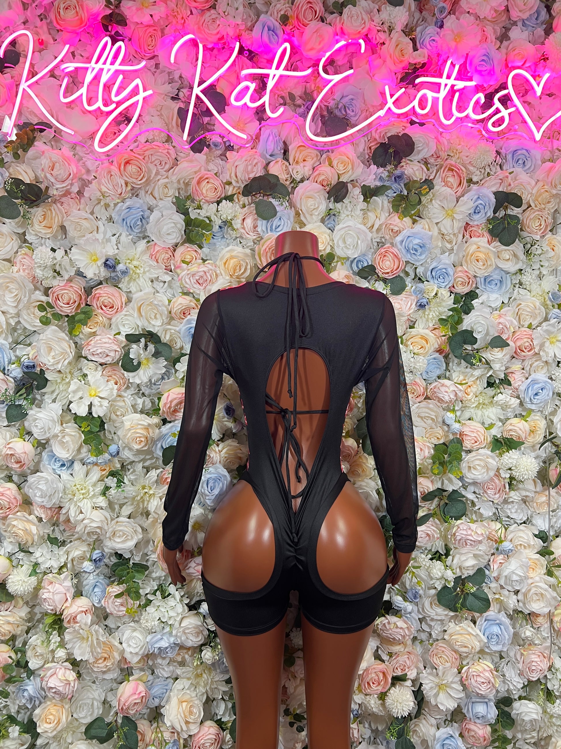 Black mesh one-piece bodysuit with red lightning print, long sleeves, crisscross back ties