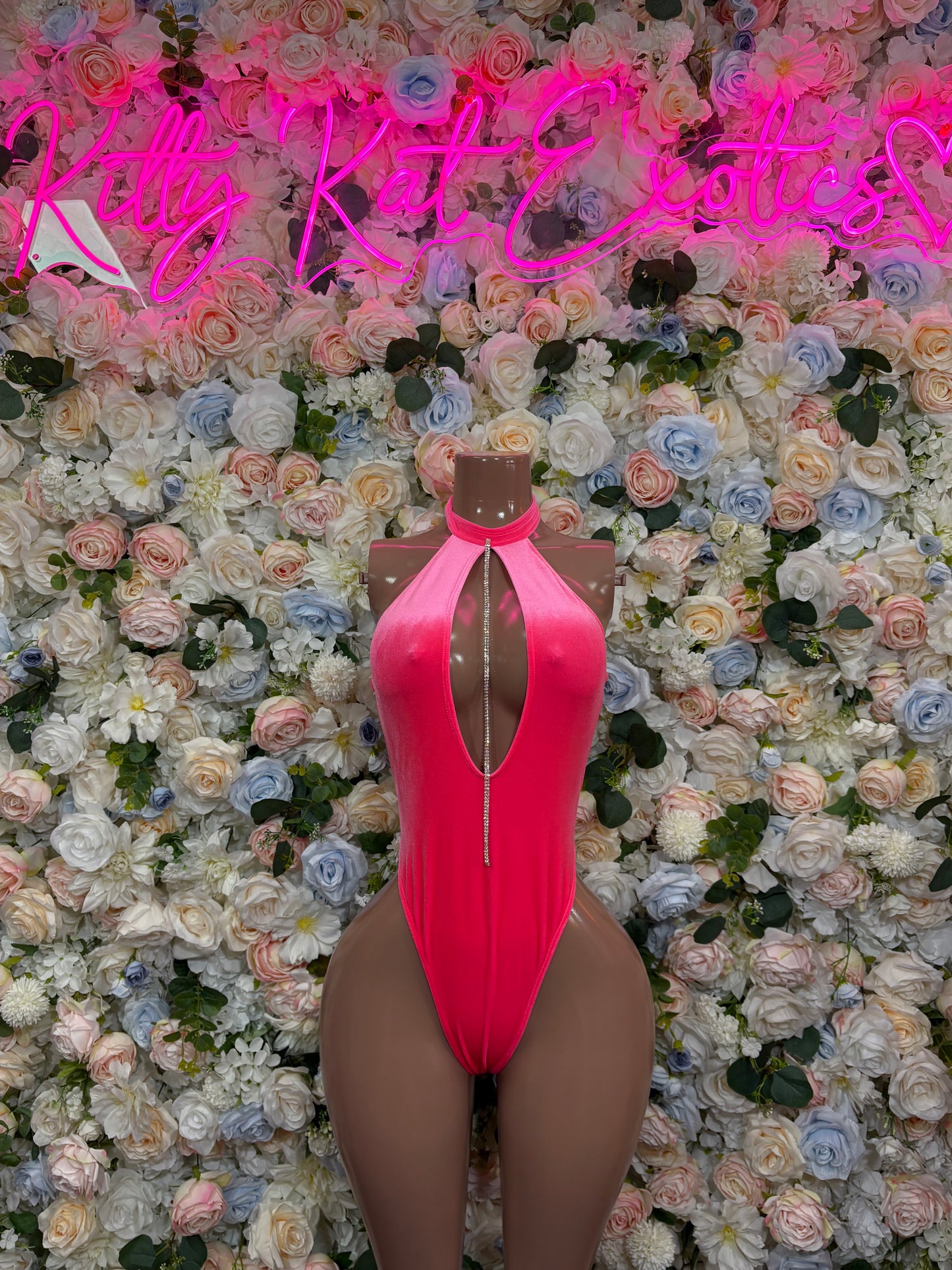 Pink halter one-piece bodysuit with open back and high-cut leg