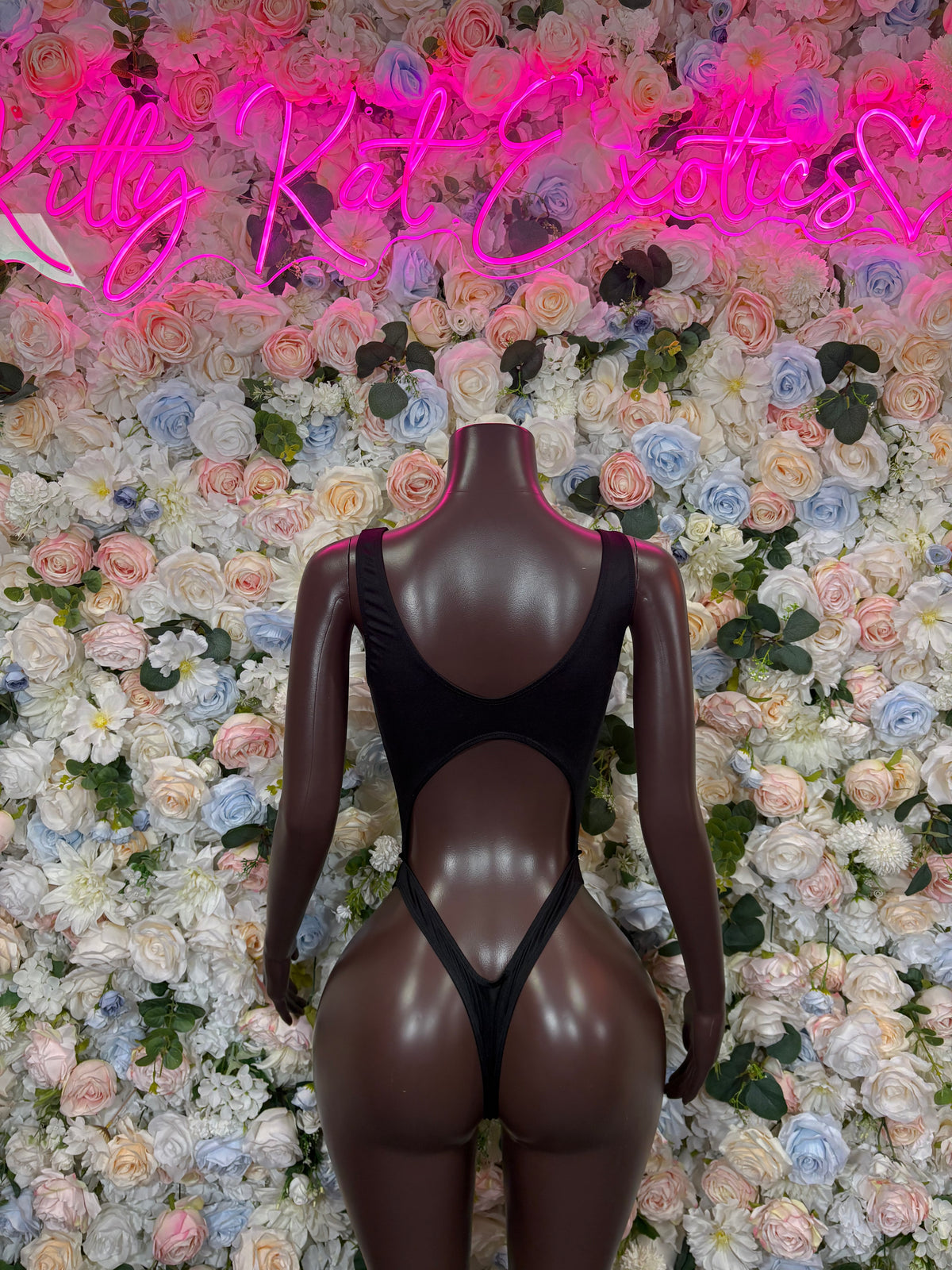 Black backless bodysuit with strappy sides and triangular back cutout