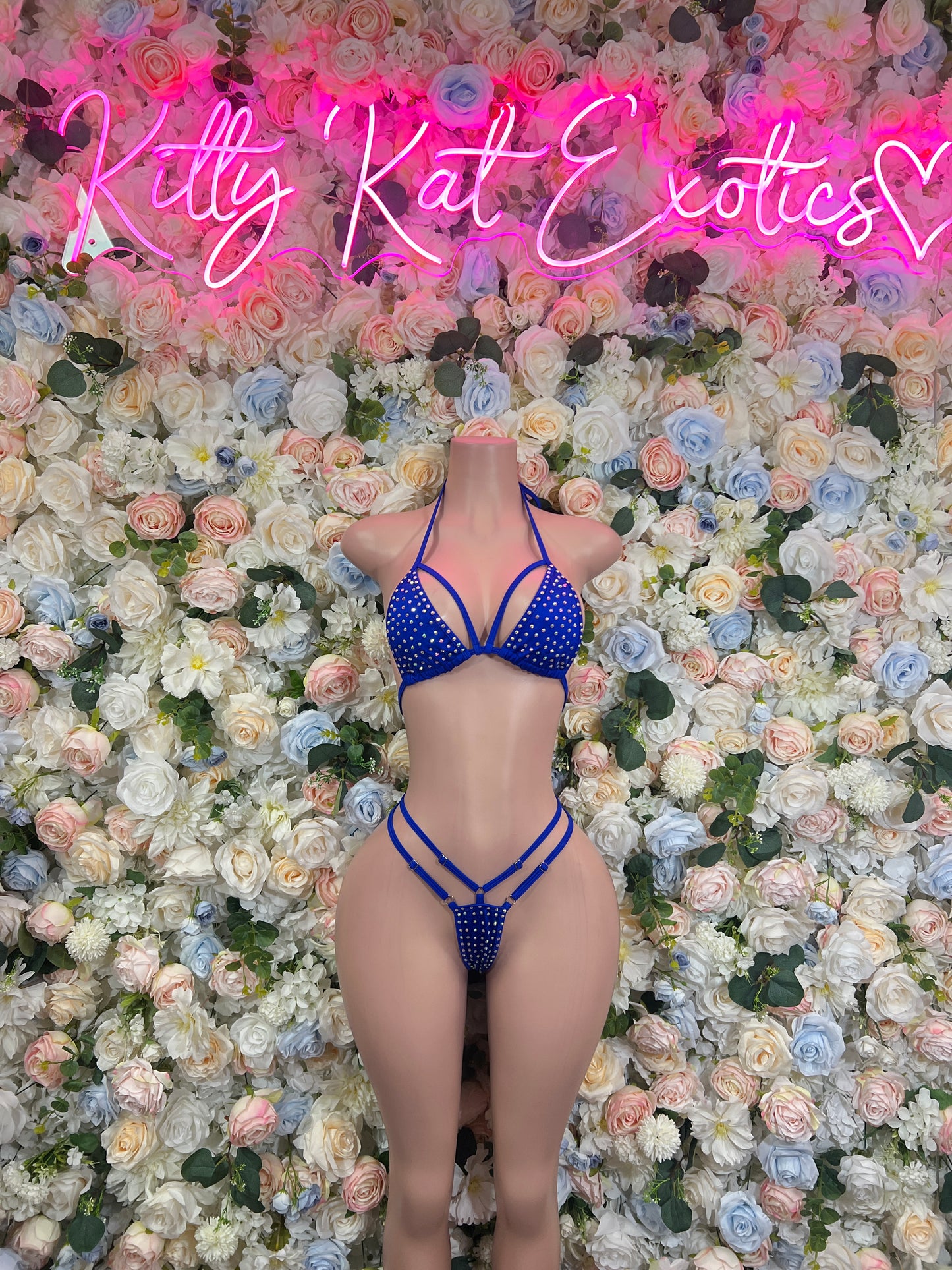Blue rhinestone bikini set with triangle top and strappy thong bottom on model