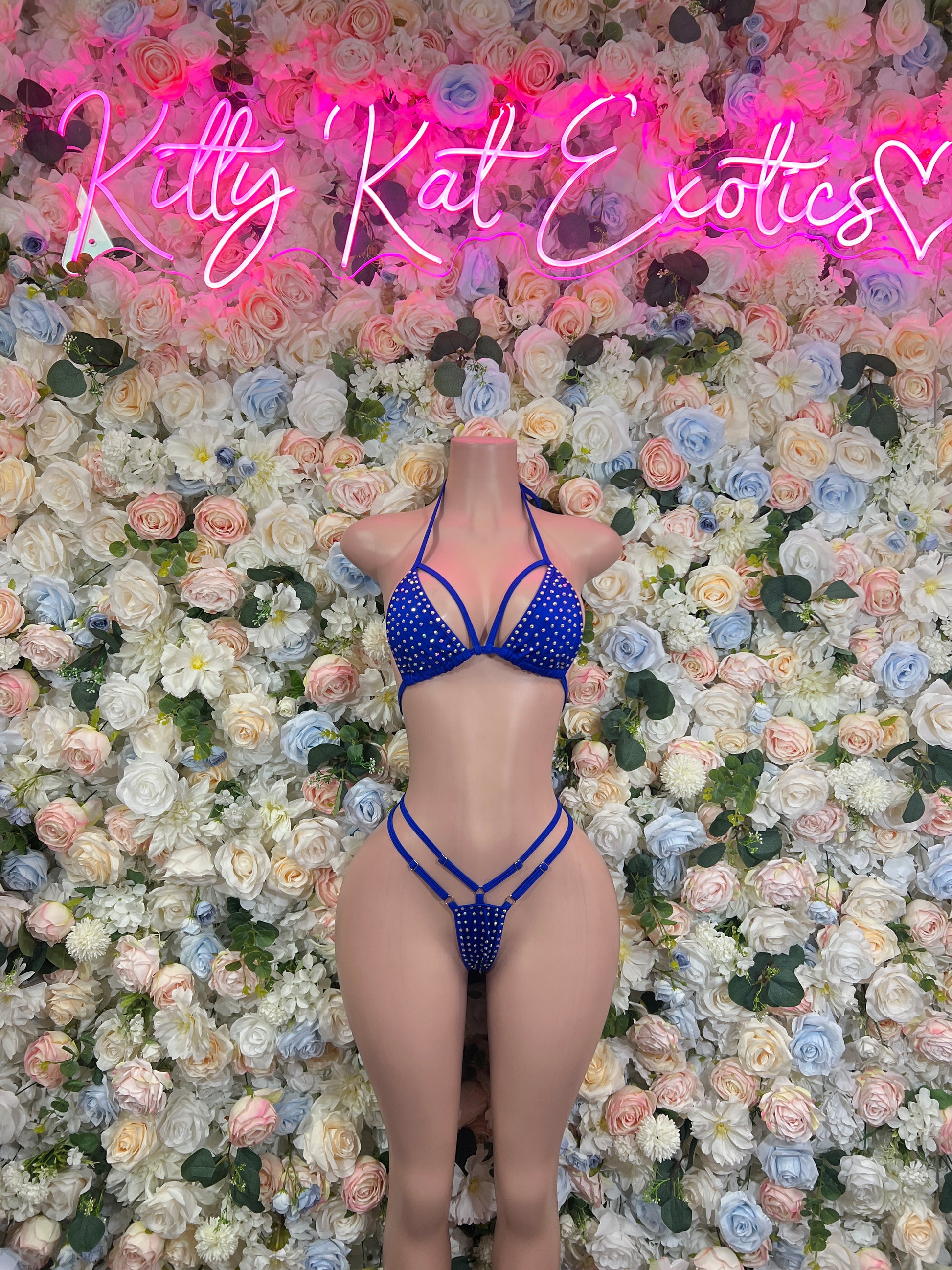 Blue rhinestone bikini set with triangle top and strappy thong bottom on model