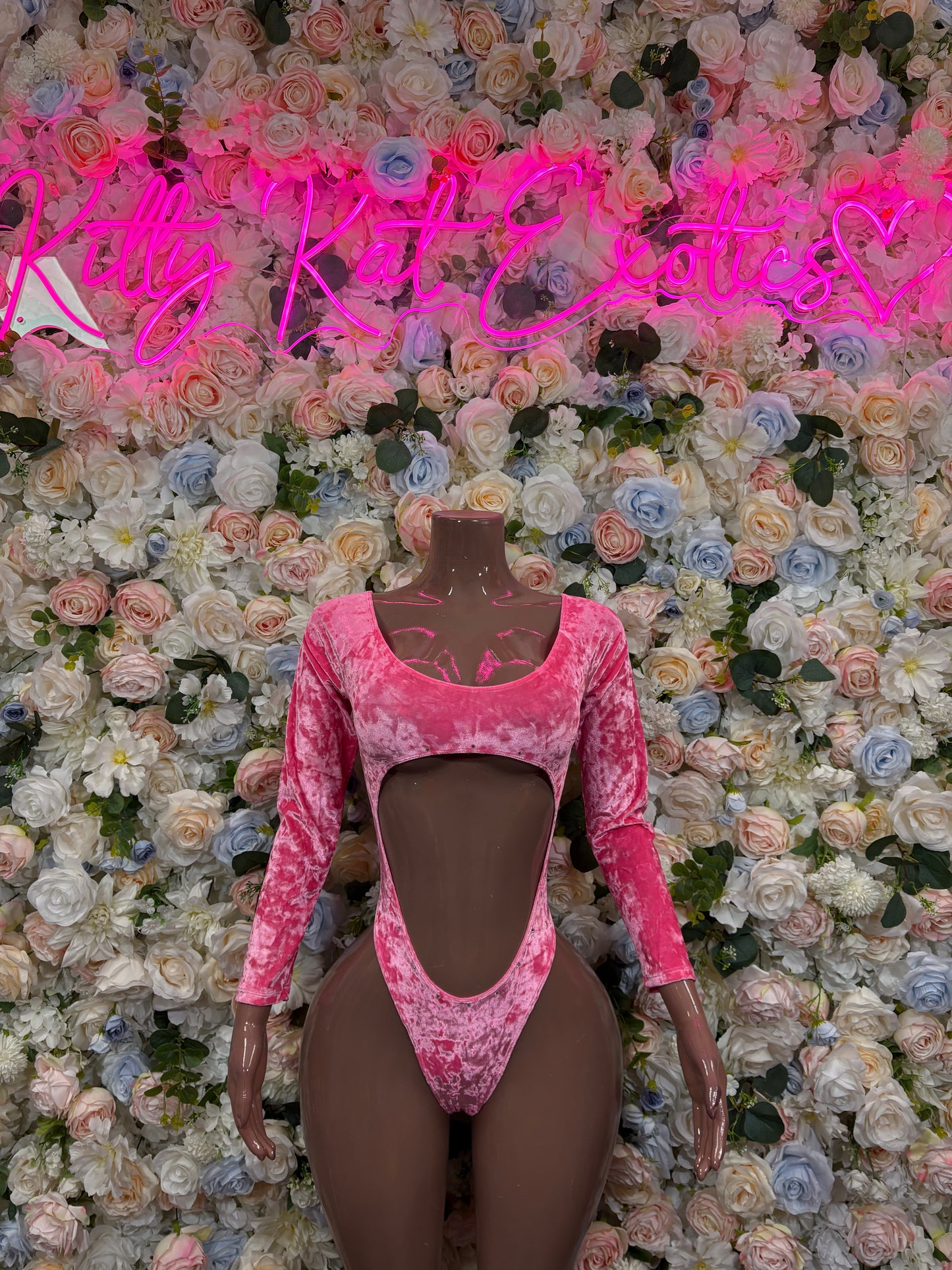 Pink velvet one-piece dancewear with long sleeves, sweetheart neckline, and mid-body cutouts