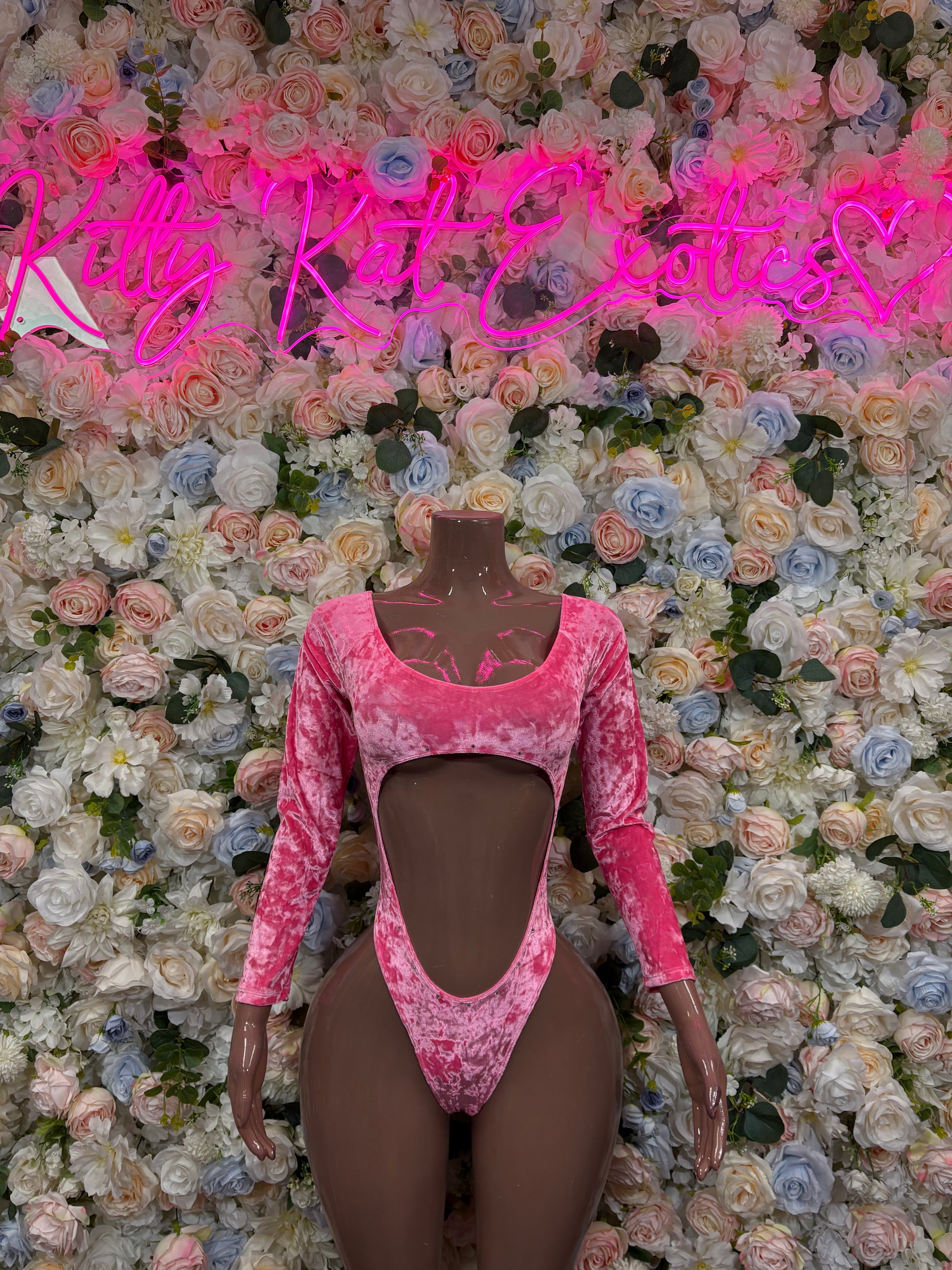 Pink velvet one-piece dancewear with long sleeves, sweetheart neckline, and mid-body cutouts