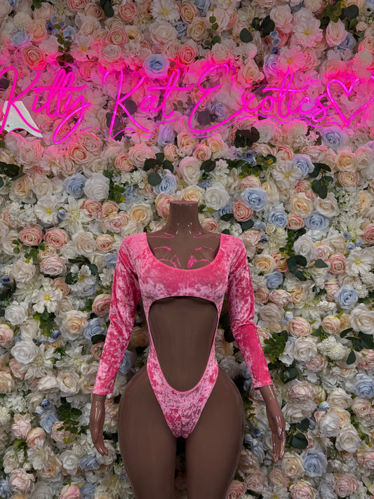 Pink velvet one-piece dancewear with long sleeves, sweetheart neckline, and mid-body cutouts