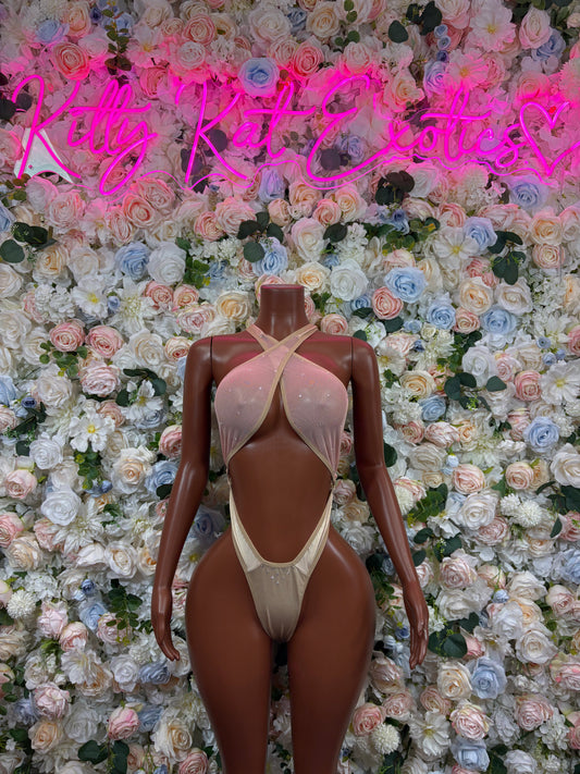 Light cream one-piece bodysuit with crisscross back straps and high-cut legs