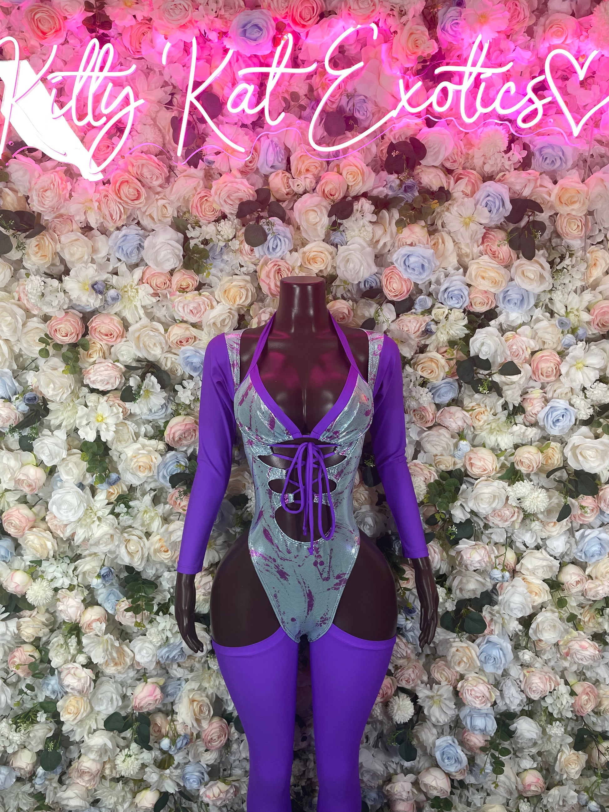 Purple one-piece bodysuit with long sleeves and lace-up front