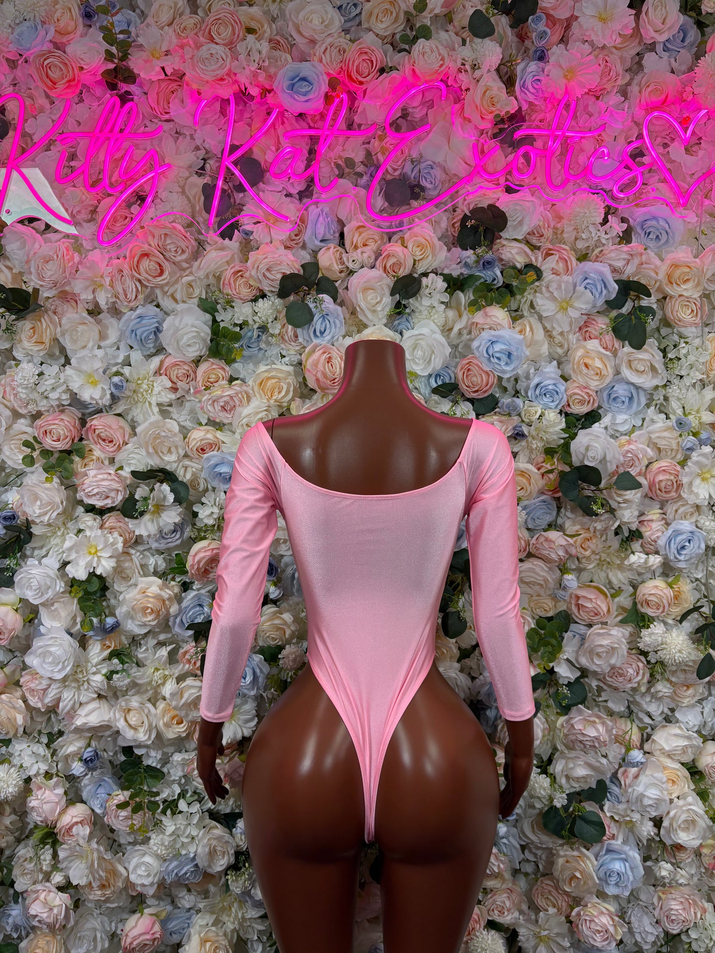 Pink long-sleeve bodysuit with scoop front and high-cut thong-style legs