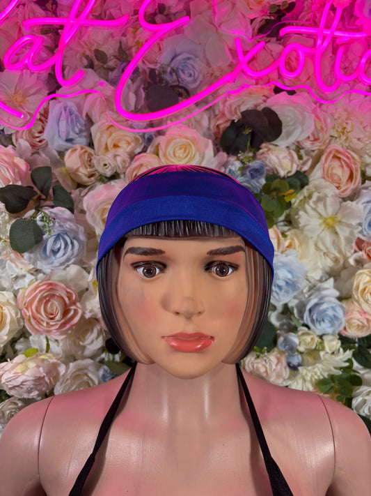 Blue headband with black long ties, worn over the hairline