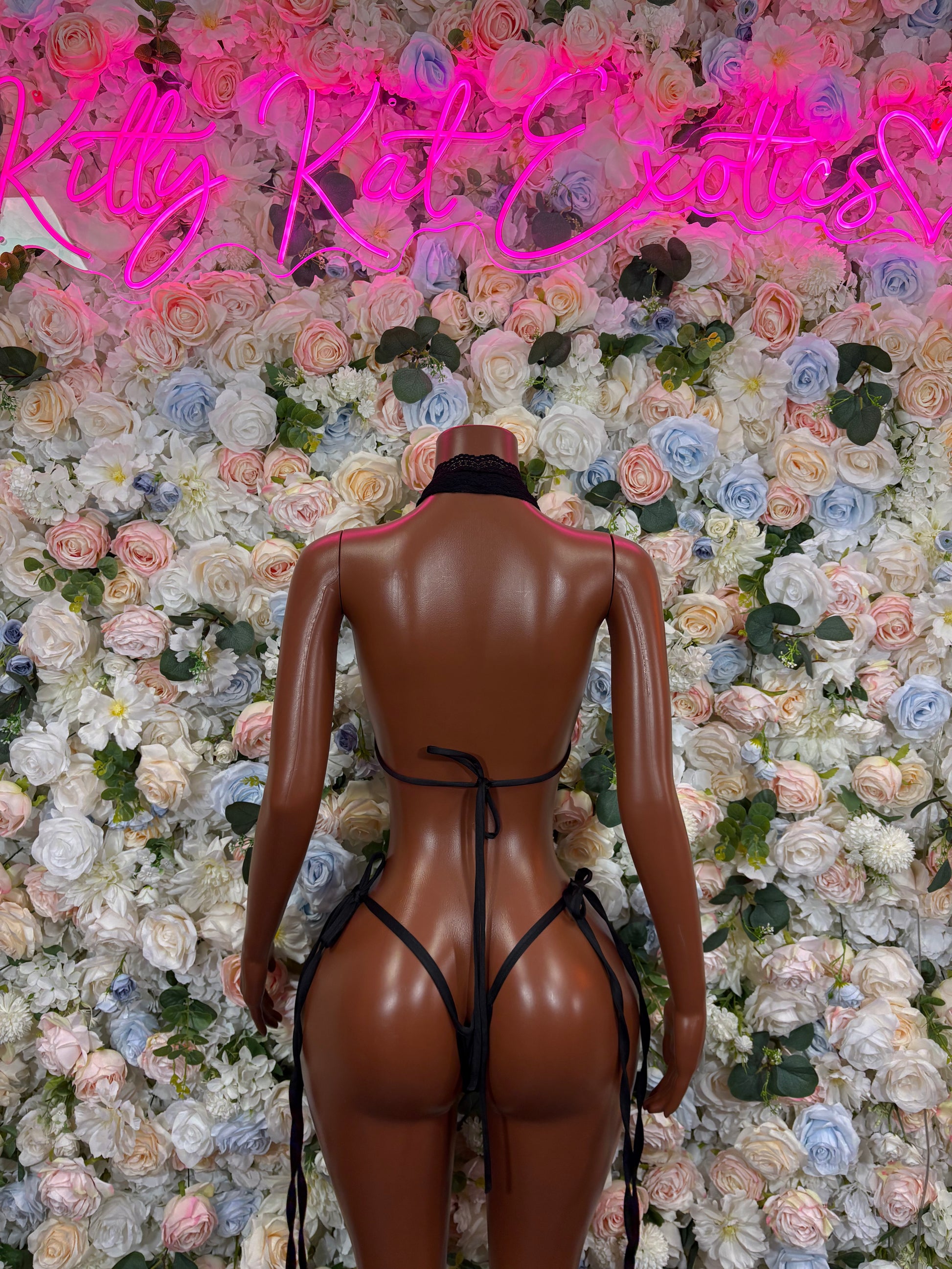 Black bikini set with crisscross tie straps on mannequin (back view)