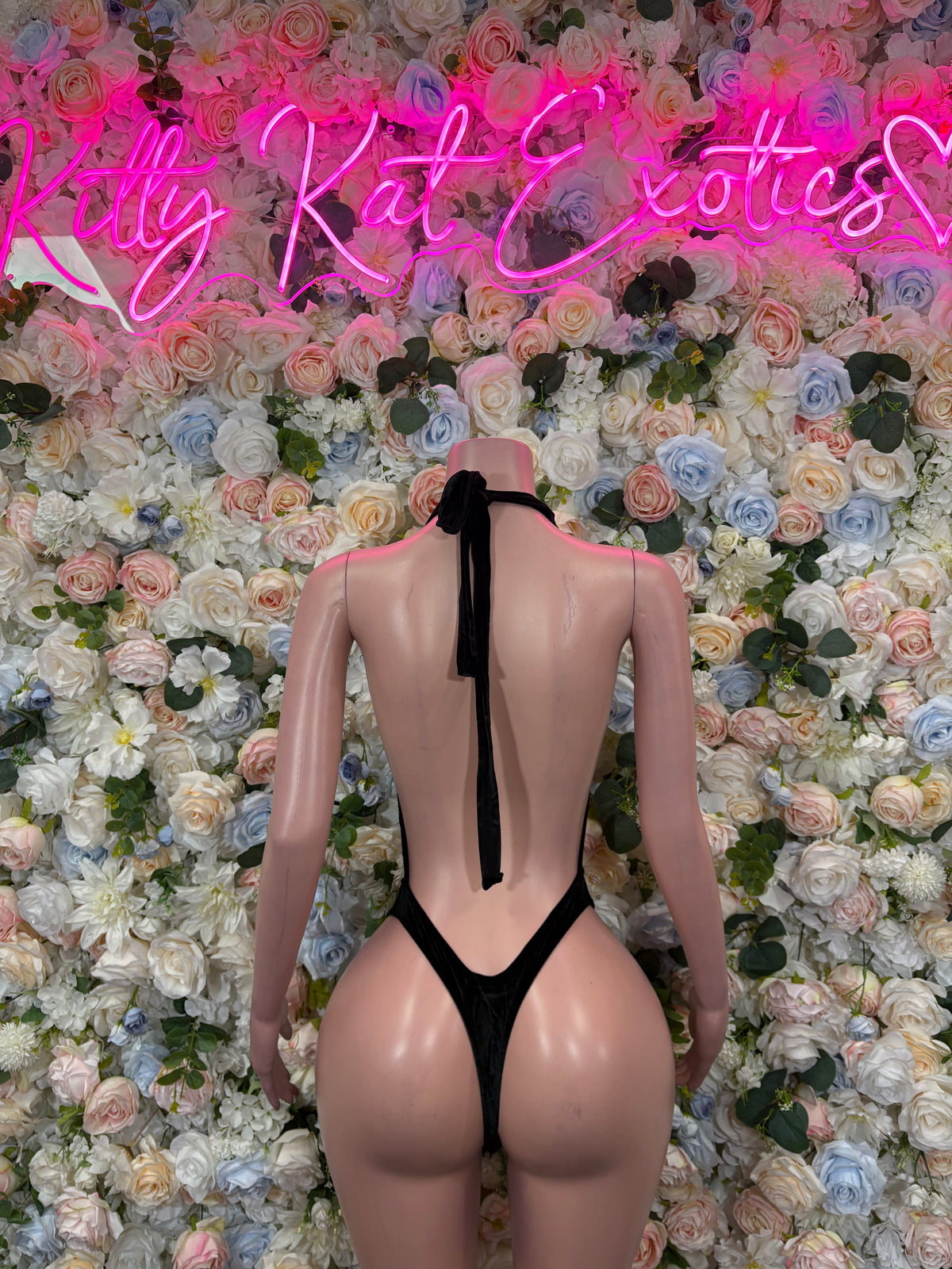 Black velvet slingshot bodysuit with backless cut and tie straps, open back thong