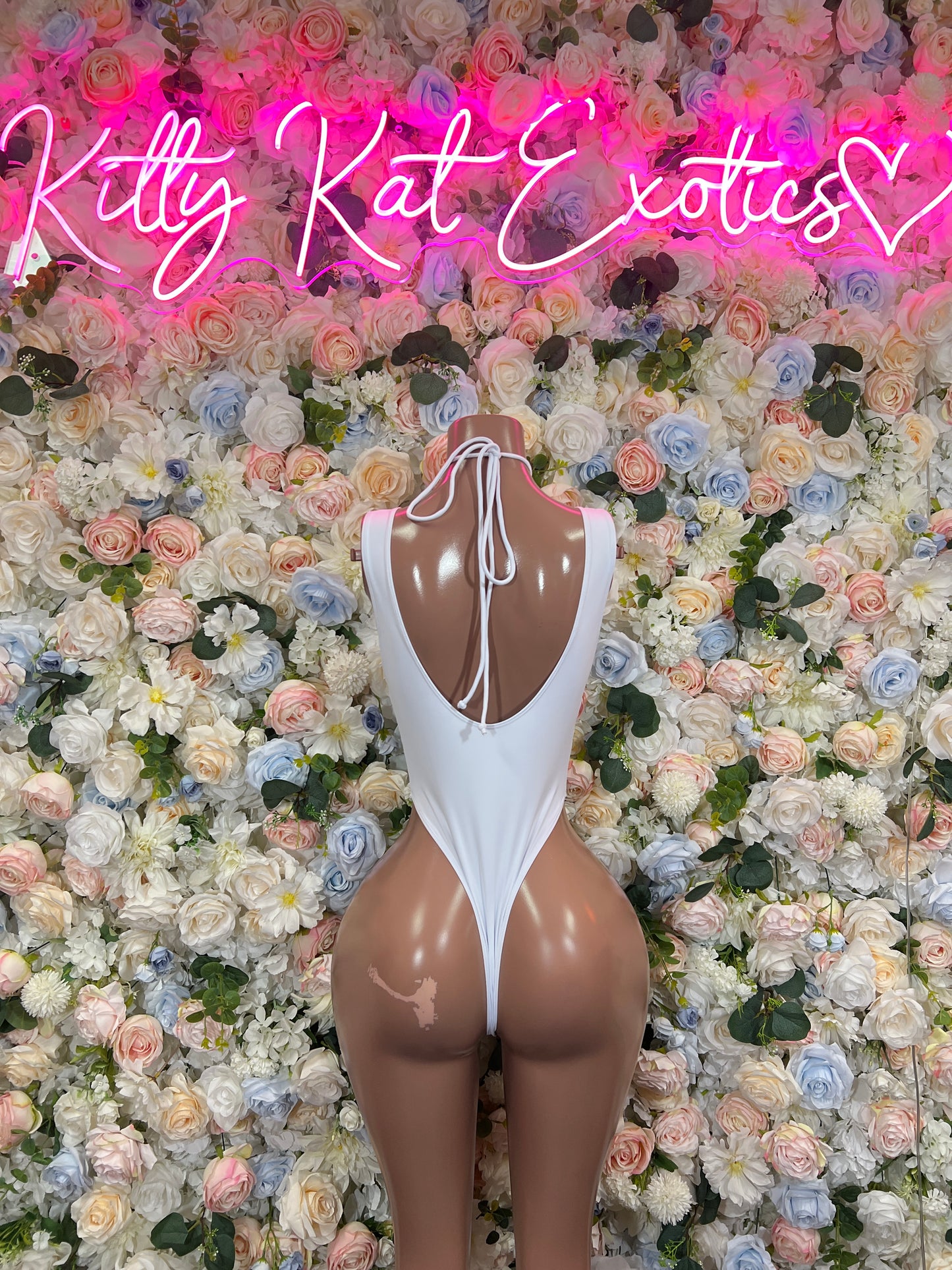 White cutout high-cut bodysuit with open back and lace-up strap center