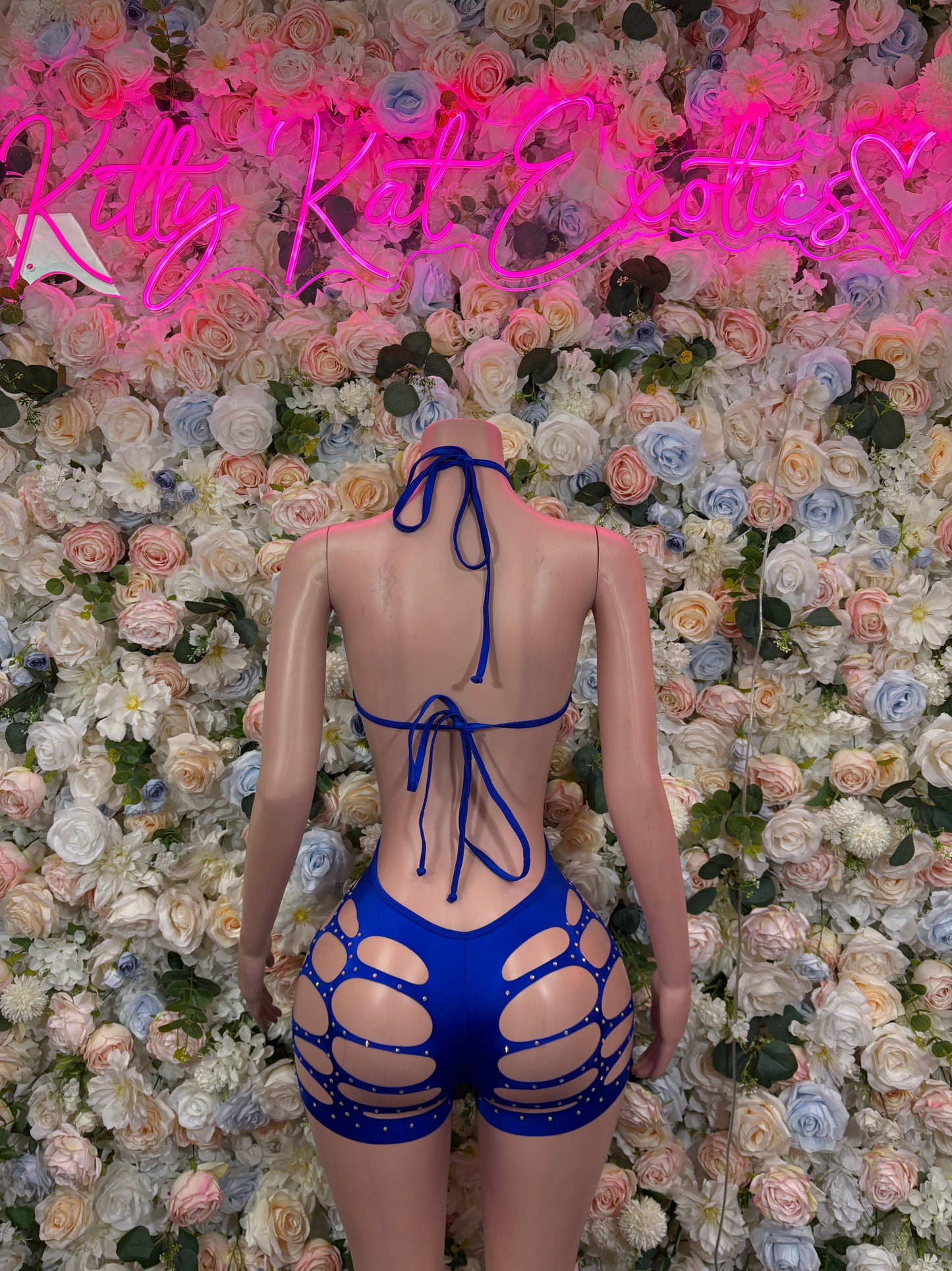 Back view of blue rhinestone bodysuit with lace-up straps and side cutouts