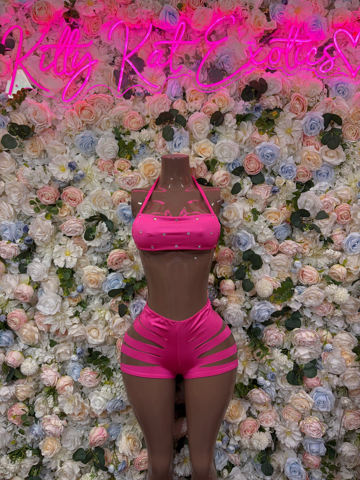 Pink two-piece rave outfit: halter crop top and high-waist cutout shorts