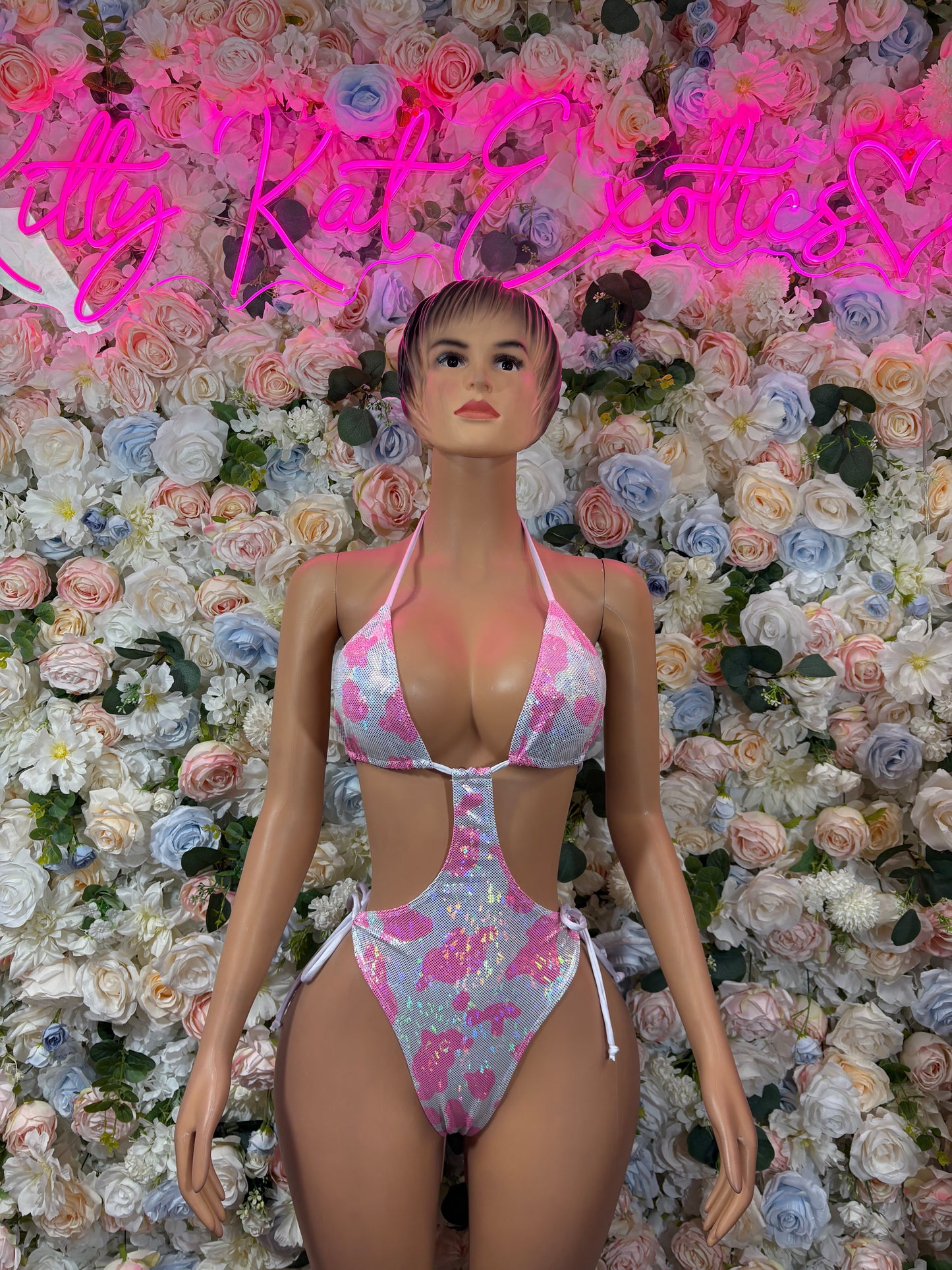 Pink and white cow-print bodysuit with triangle top and thong bottom