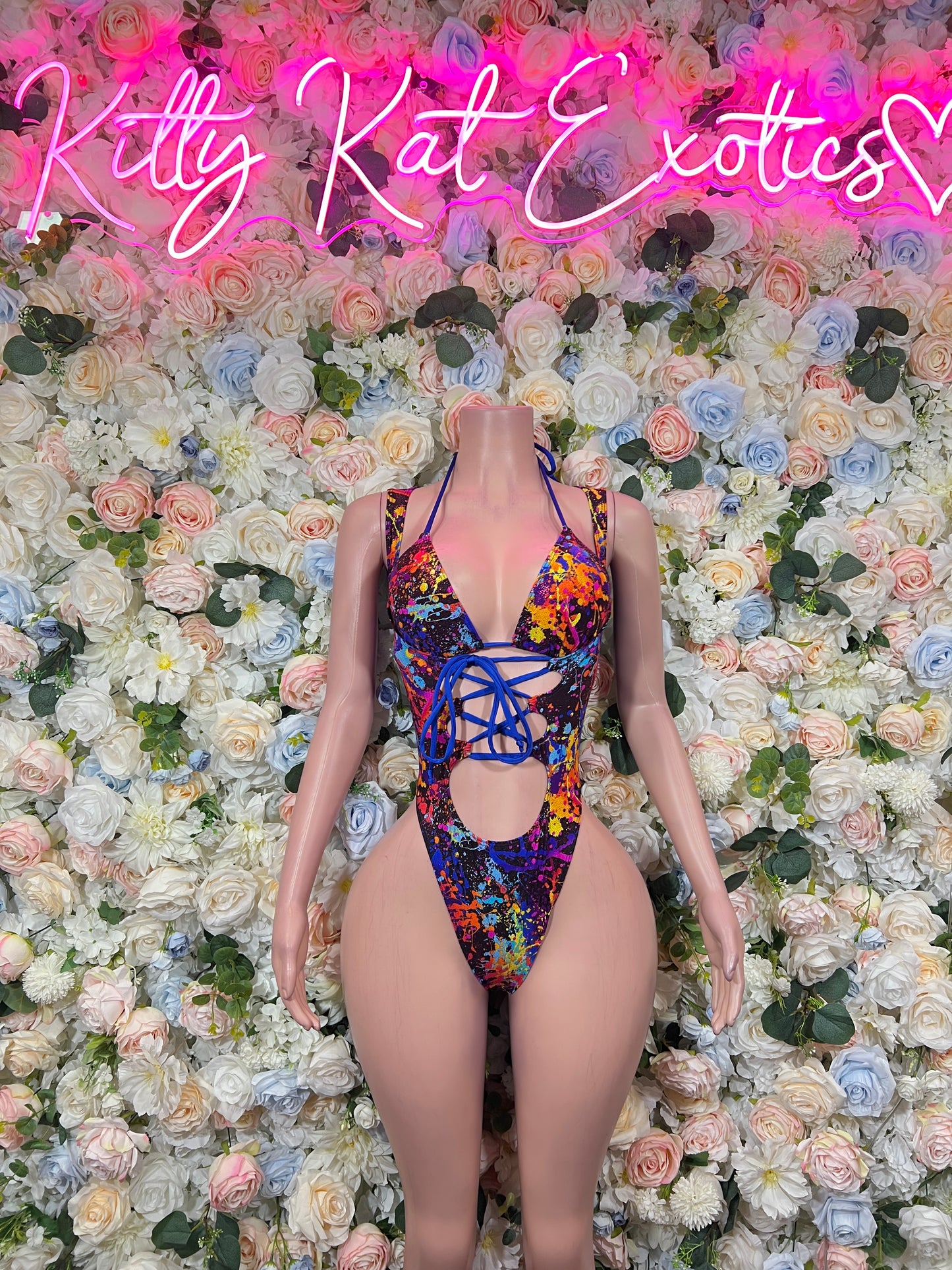 Multicolor paint-splatter thong bodysuit with crisscross lace-up front and cheeky cutout