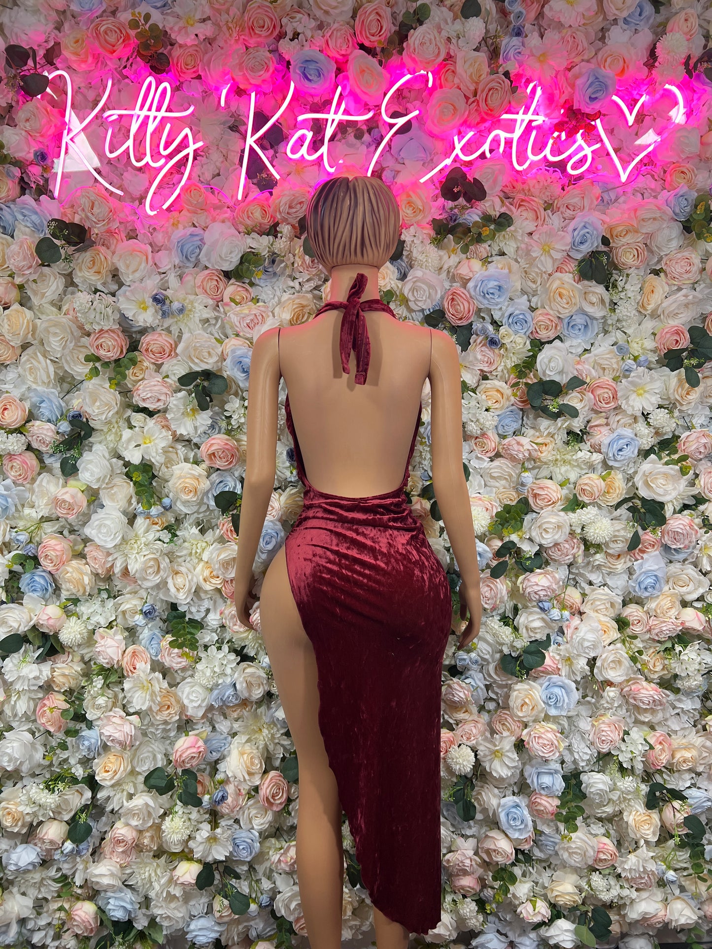 Burgundy backless gown with tie halter and open back, side slit.