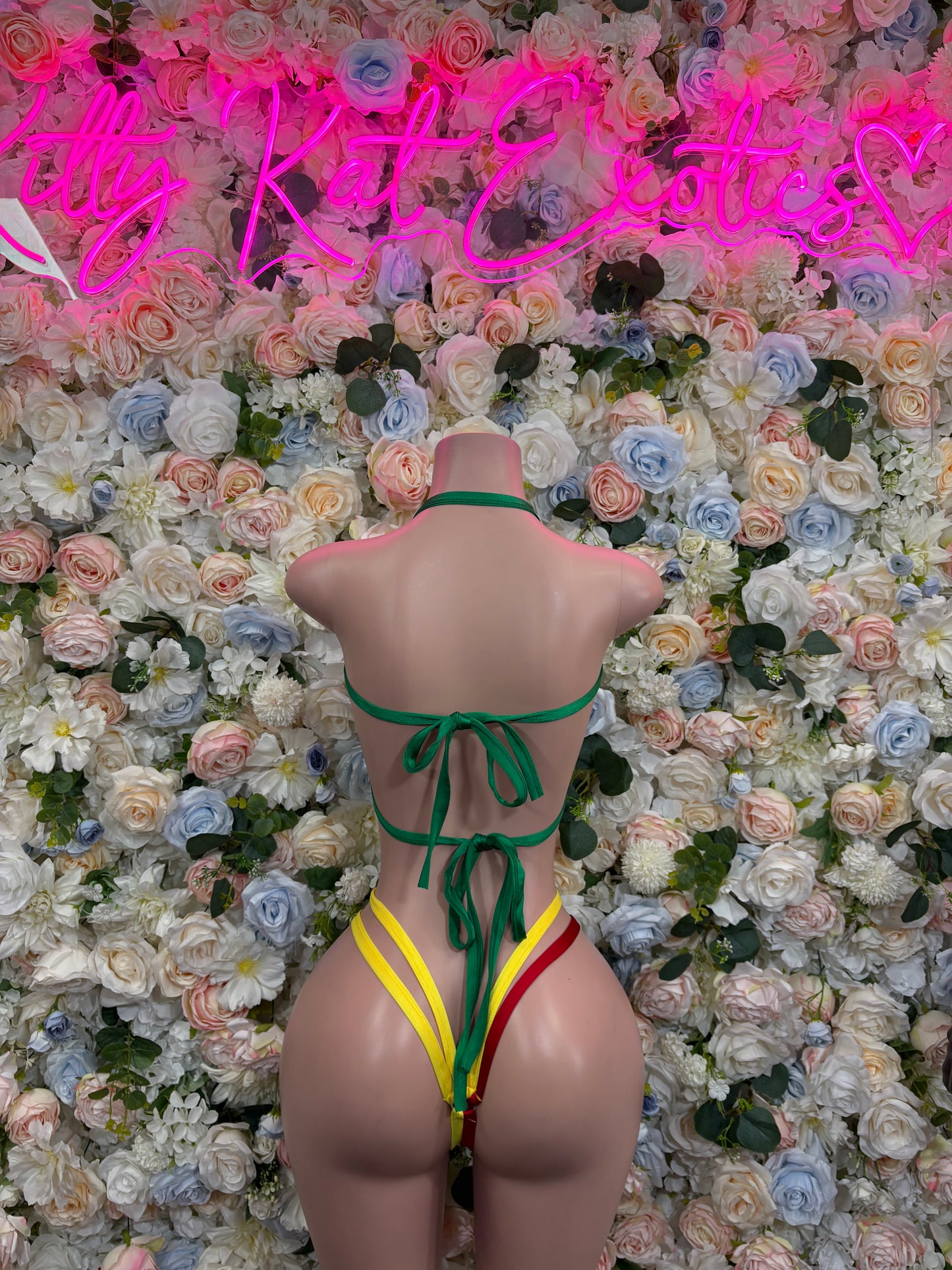 Back view flag bikini swimsuit with green yellow red straps and crisscross tie bottoms