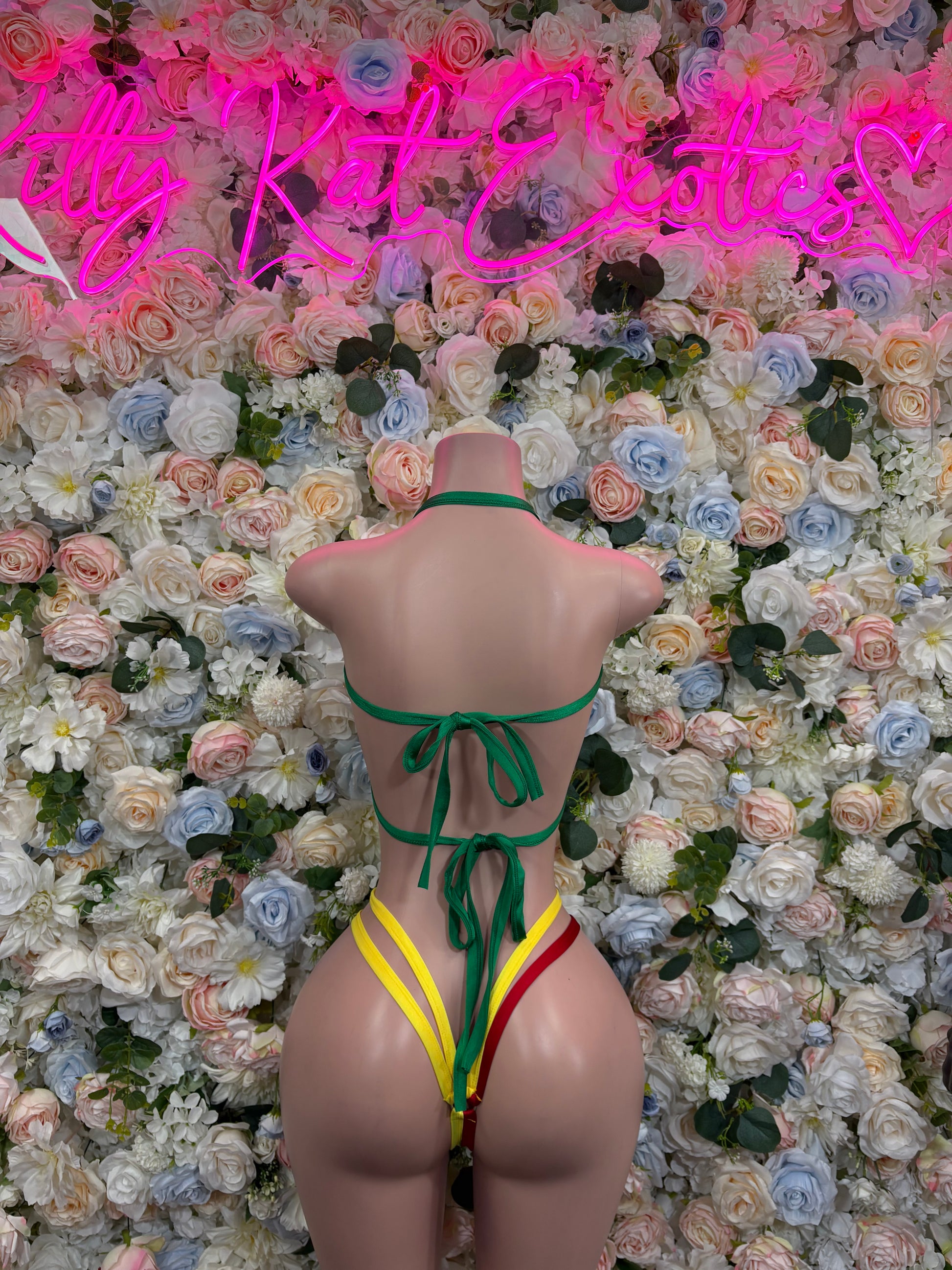 Back view flag bikini swimsuit with green yellow red straps and crisscross tie bottoms