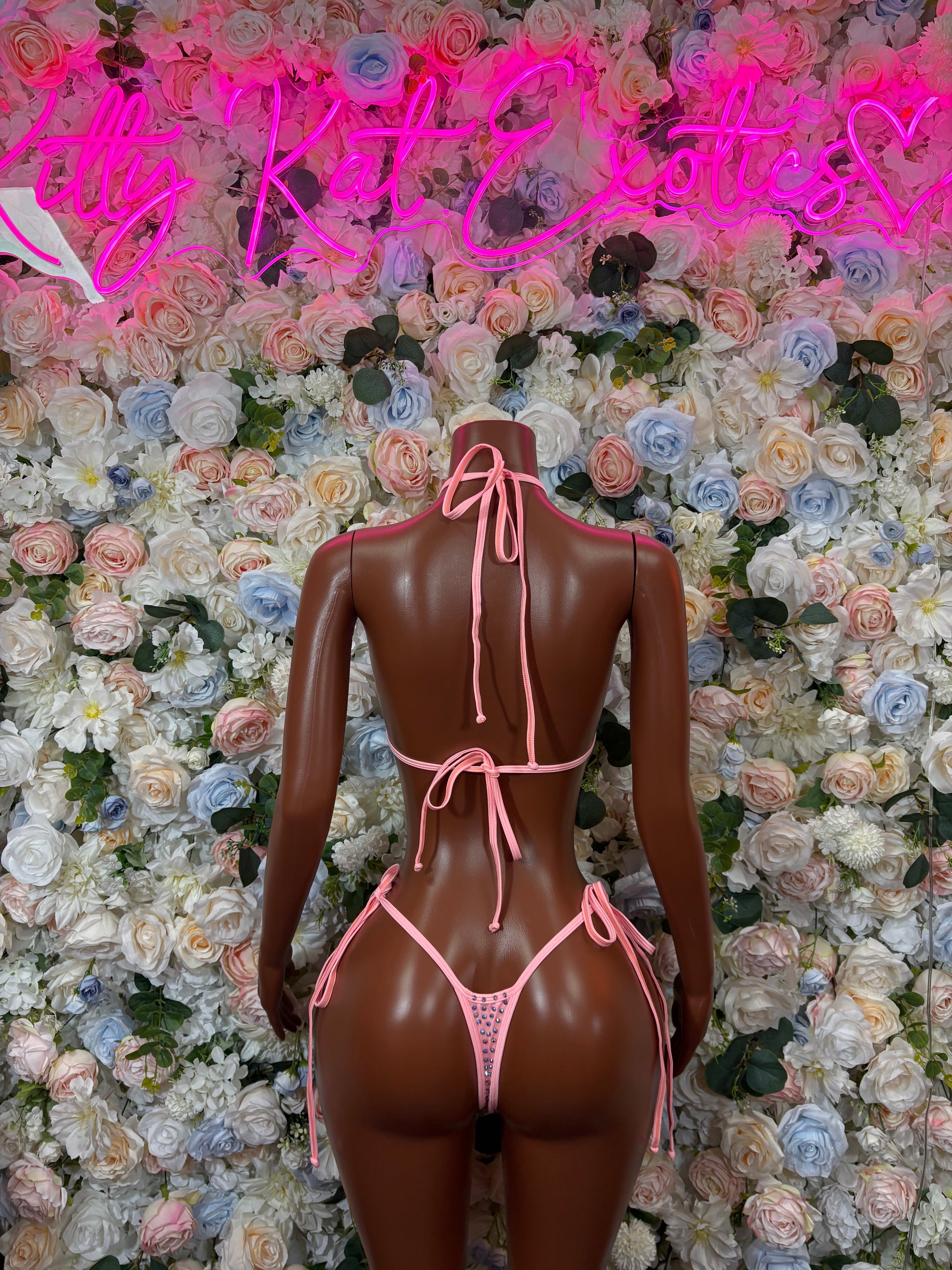 Pink rhinestone bikini set with triangle ties, shown from the back on a mannequin