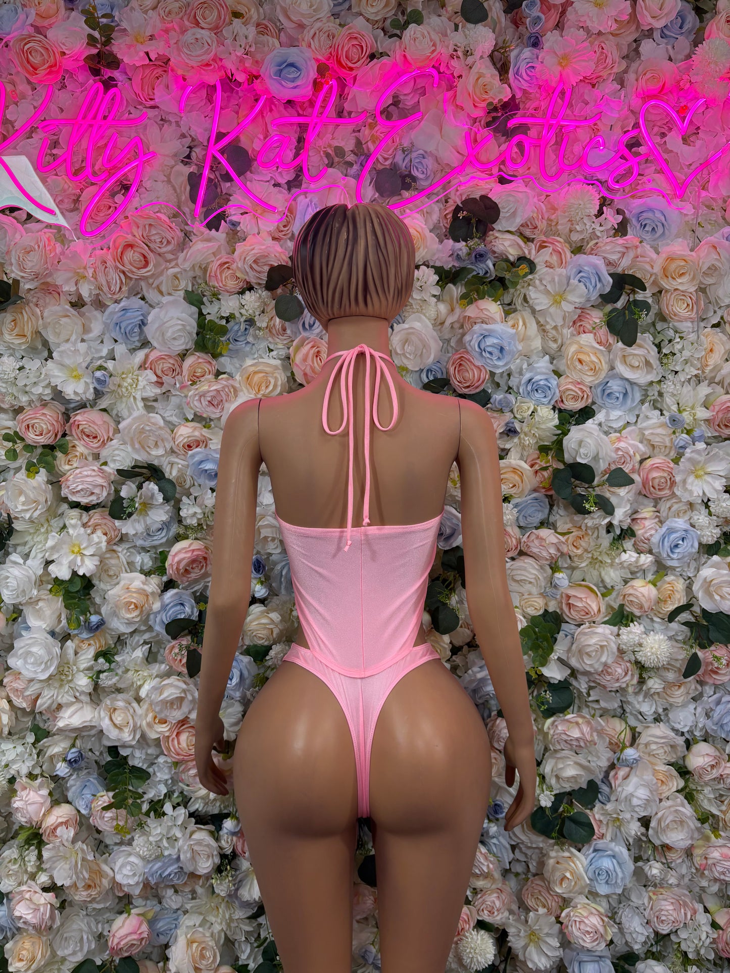 Pink halter bodysuit with open back and long tie straps