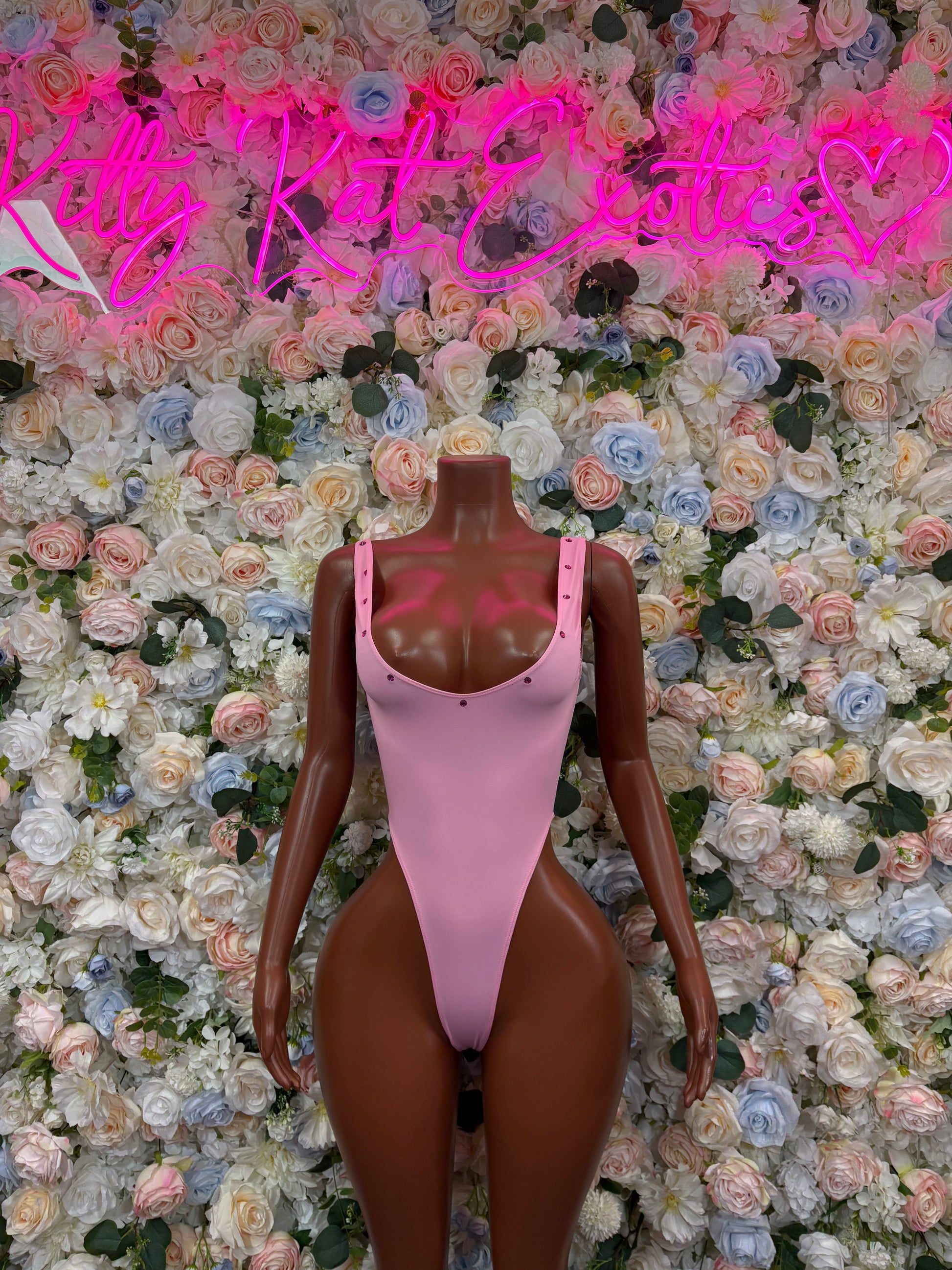 Pink one-piece bodysuit with V-neck and thong back