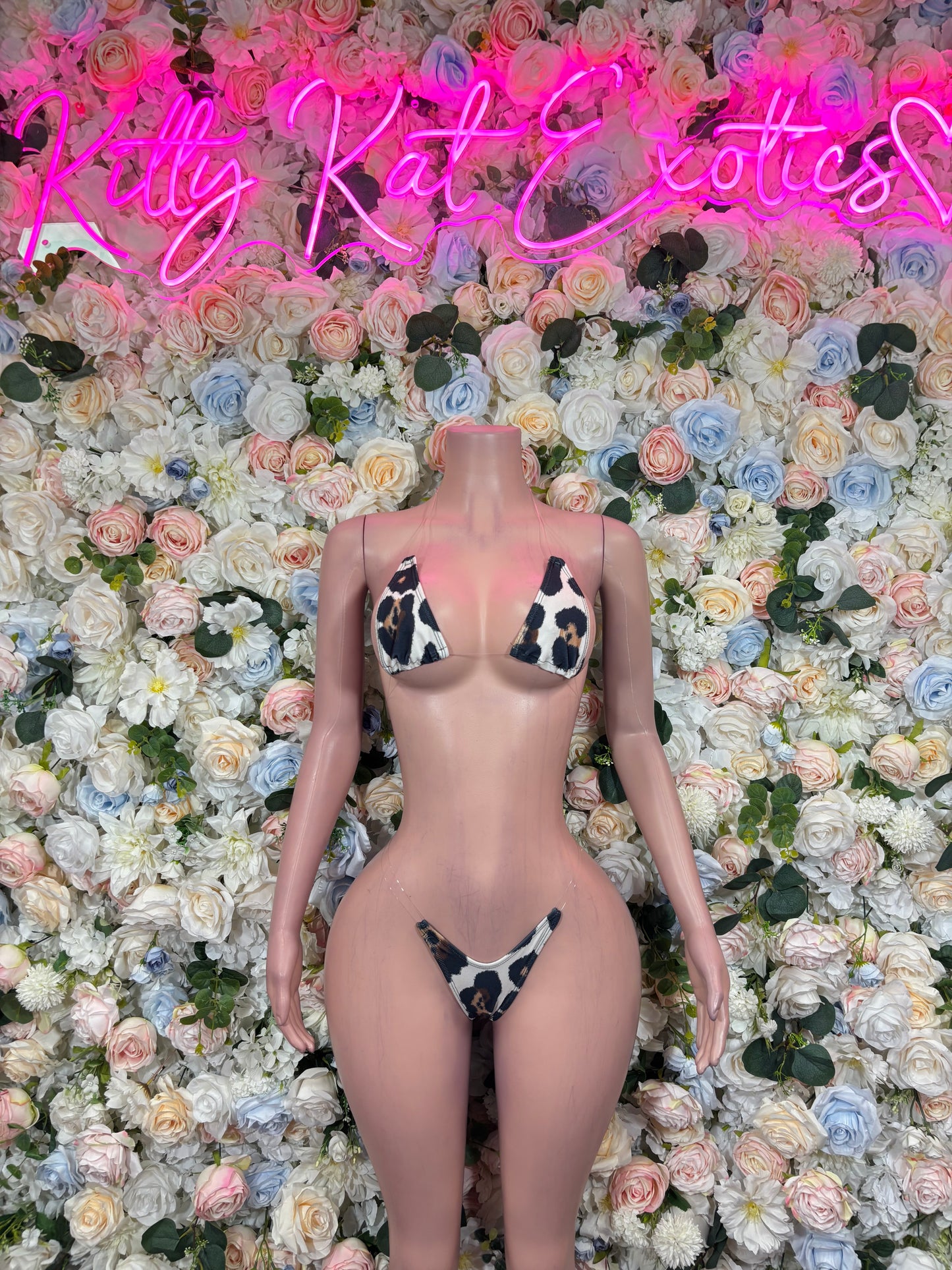 Giraffe-print g-string bikini on mannequin, front view with triangle top and thong bottom