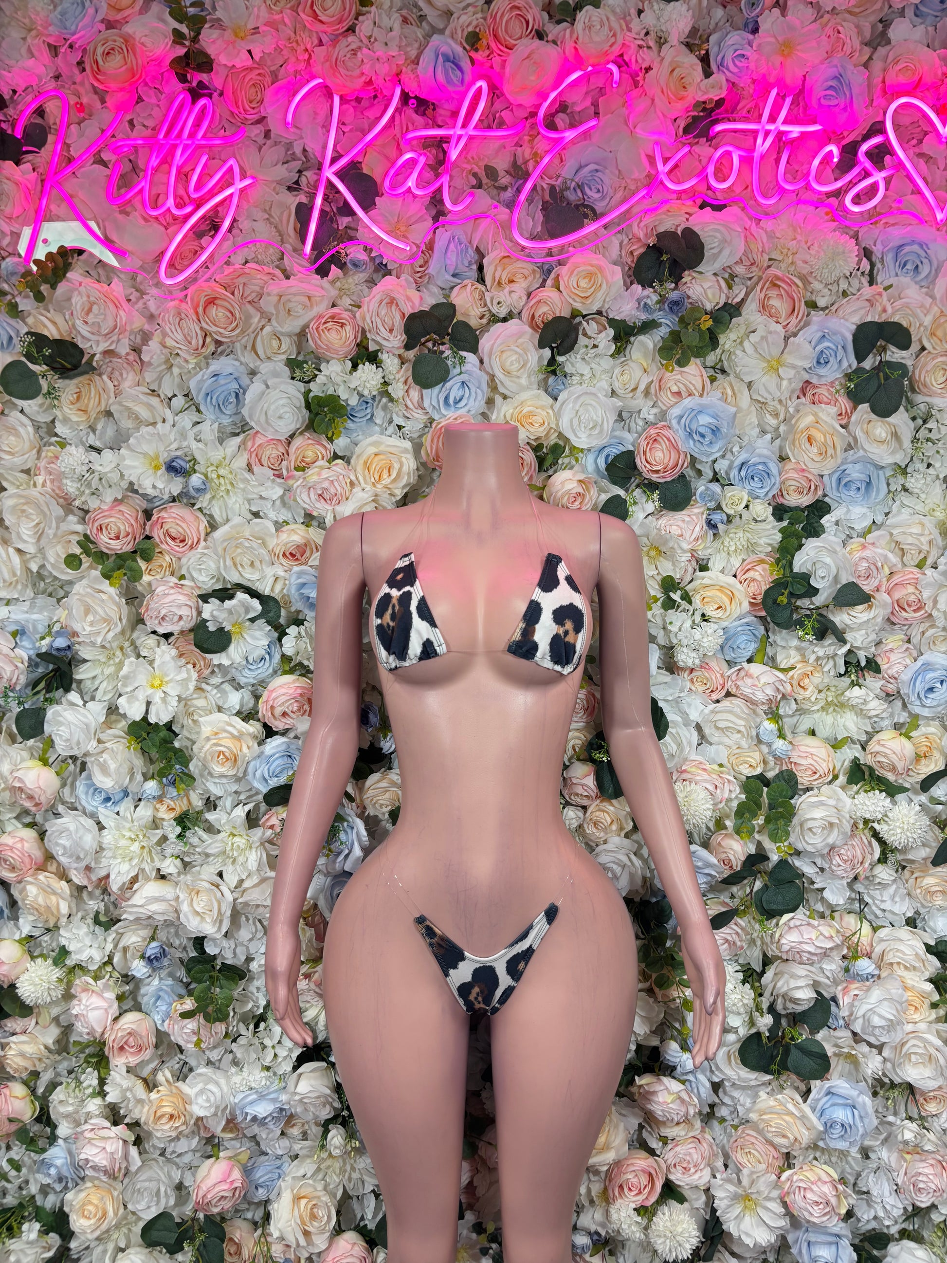 Giraffe-print g-string bikini on mannequin, front view with triangle top and thong bottom