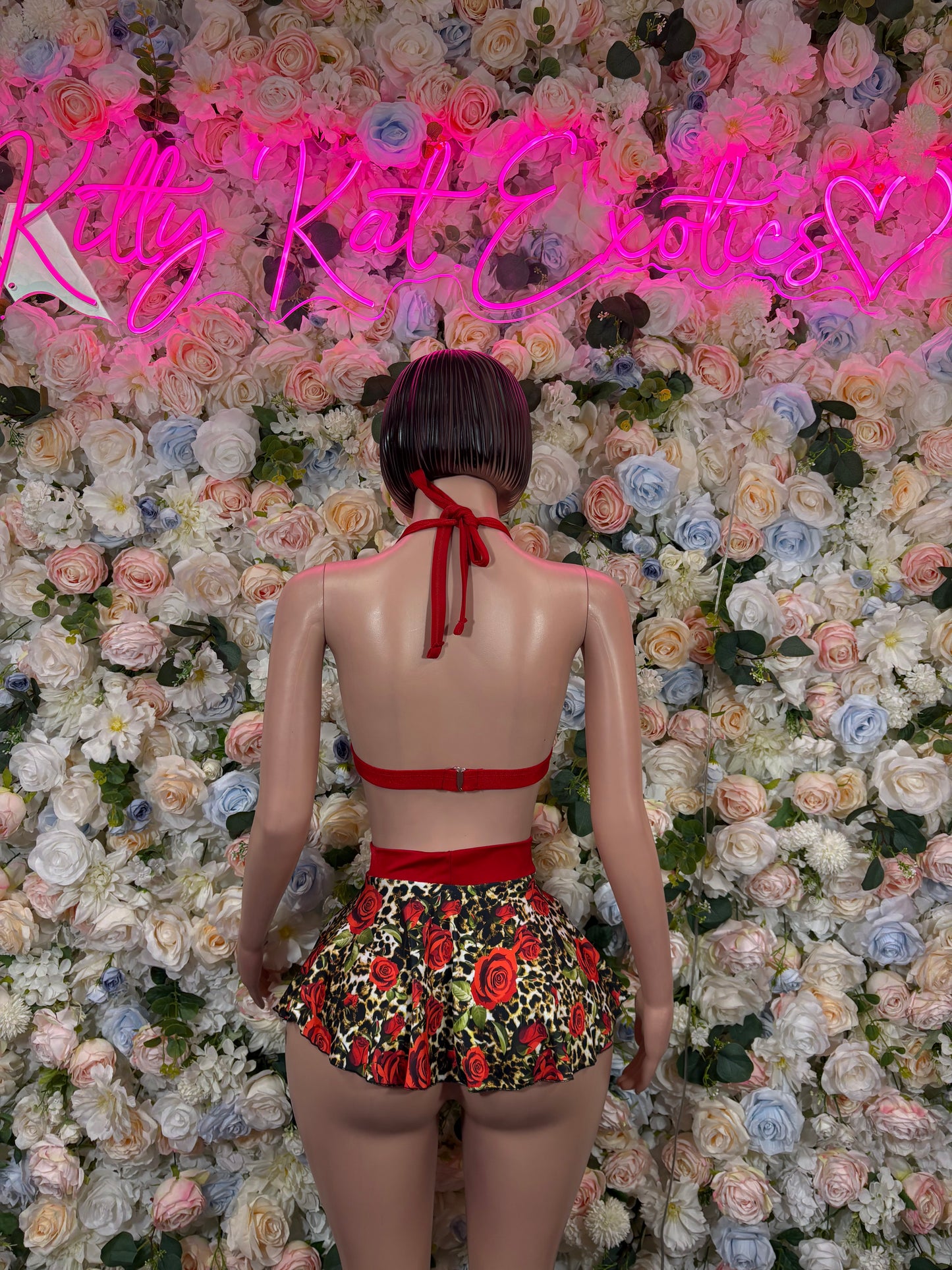 Rose print skirt set back view: red string bra and black floral rose ruffle skirt
